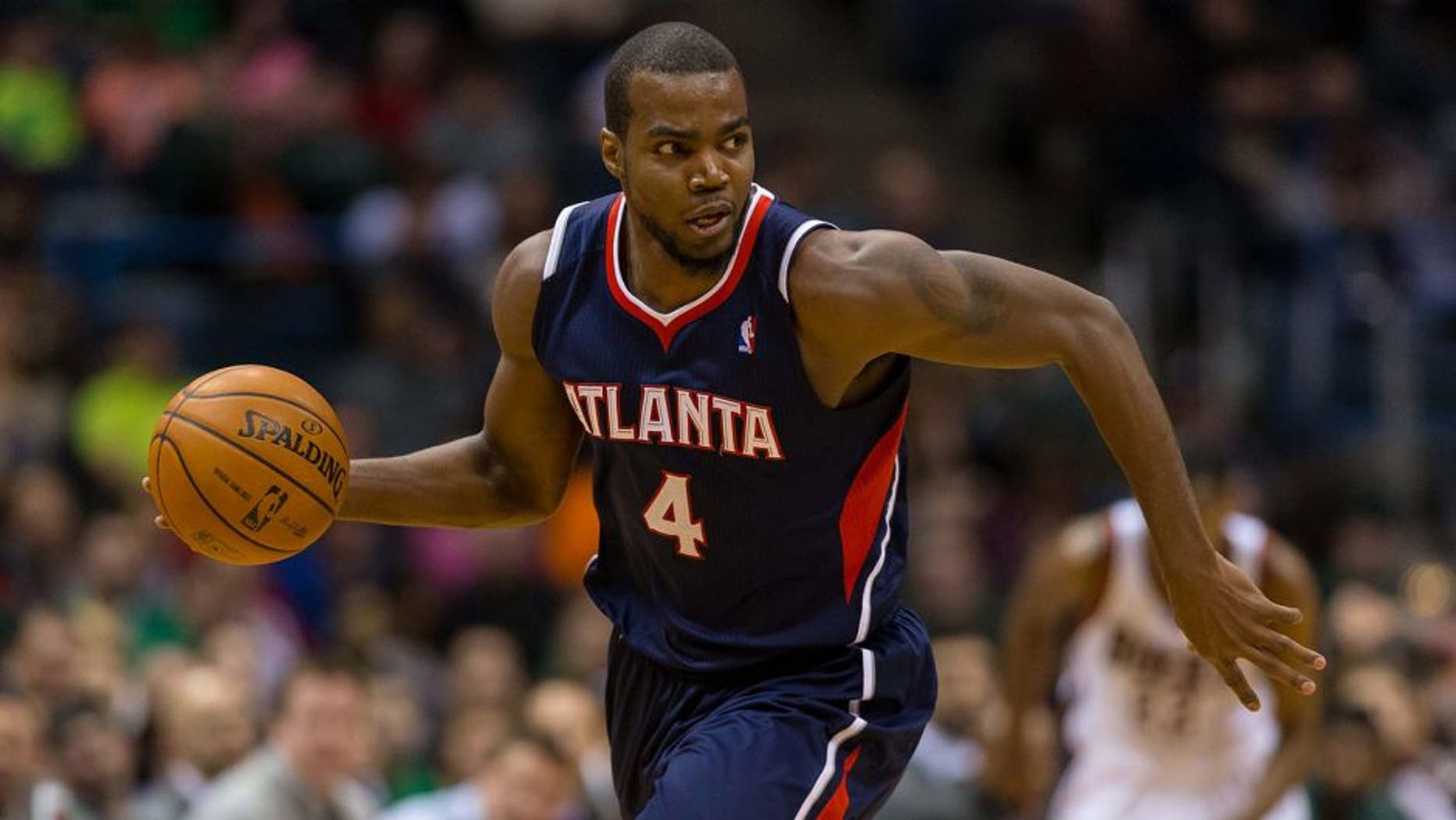 Jan 25, 2014; Milwaukee, WI, USA; Atlanta Hawks forward Paul Millsap (4) during the game against the Milwaukee Bucks at BMO Harris Bradley Center. Atlanta won 112-87. Mandatory Credit: Jeff Hanisch-USA TODAY Sports