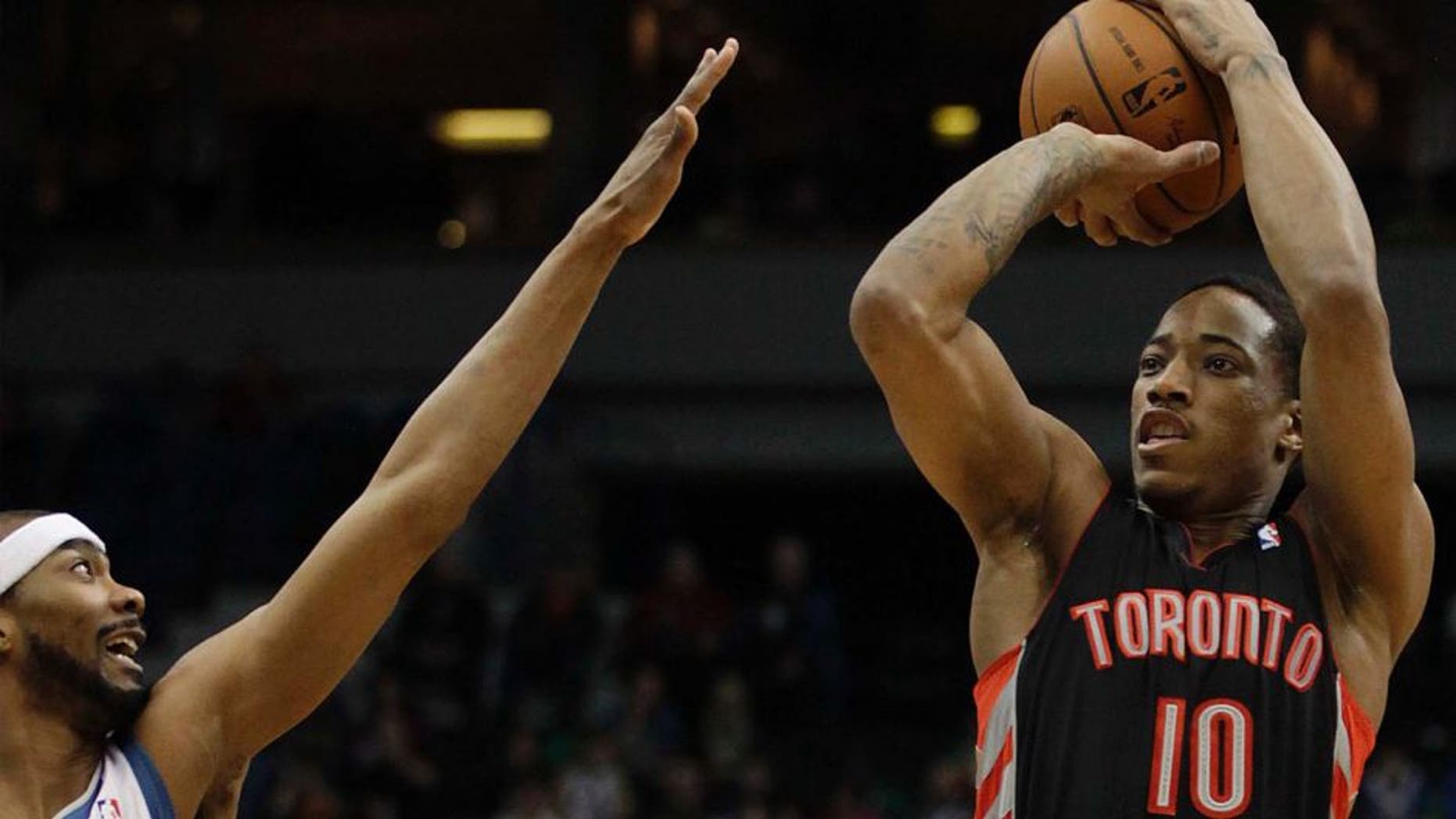 Toronto Raptors guard DeMar DeRozan (right) shoots against Minnesota Timberwolves guard Corey Brewer in the first half.