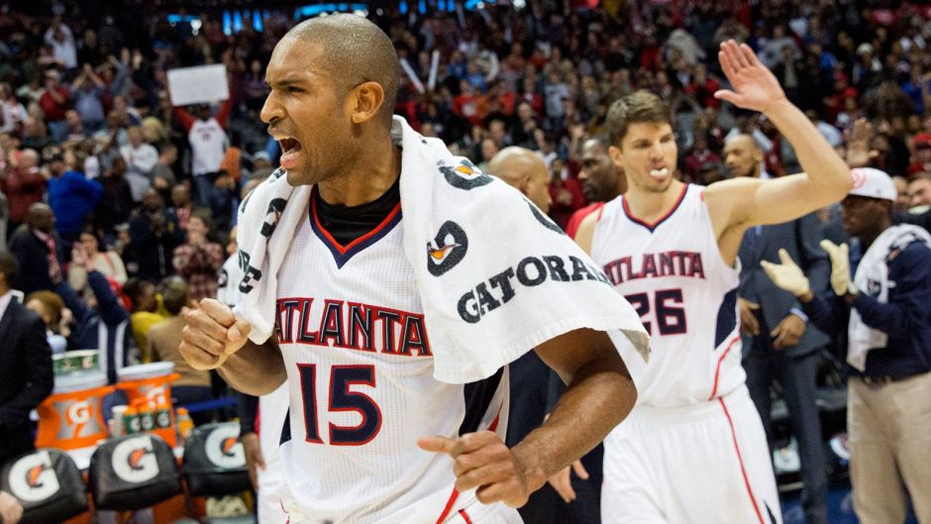 Atlanta Hawks' Al Horford, left, celebrates along with teammate Kyle Korver, right, after they defeated the Oklahoma City Thunder 103-93 to set a franchise record for most consecutive wins at 15 in an NBA basketball game, Friday, Jan. 23, 2015, in Atlanta. (AP Photo/David Goldman)