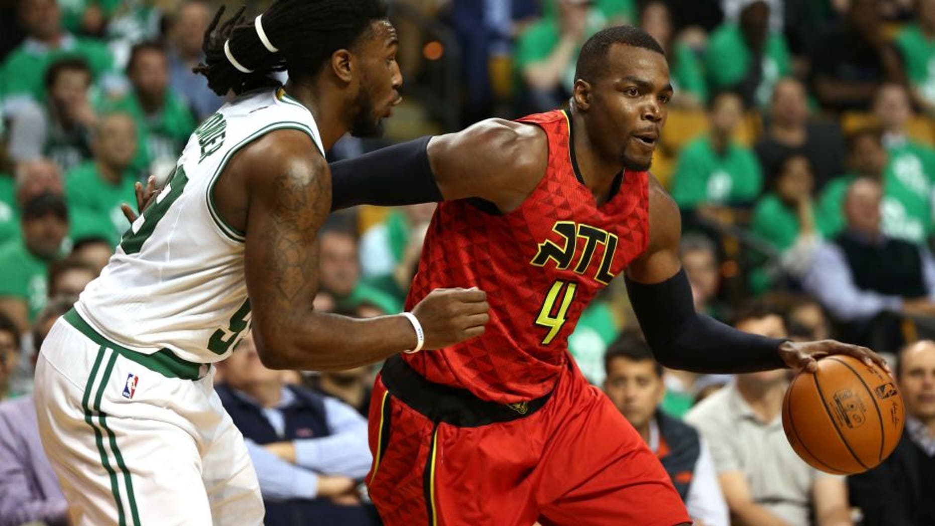 Apr 28, 2016; Boston, MA, USA; Atlanta Hawks forward Paul Millsap (4) drives to the hoop against Boston Celtics forward Jae Crowder (left) during the second half in game six of the first round of the NBA Playoffs at TD Garden. Mandatory Credit: Mark L. Baer-USA TODAY Sports