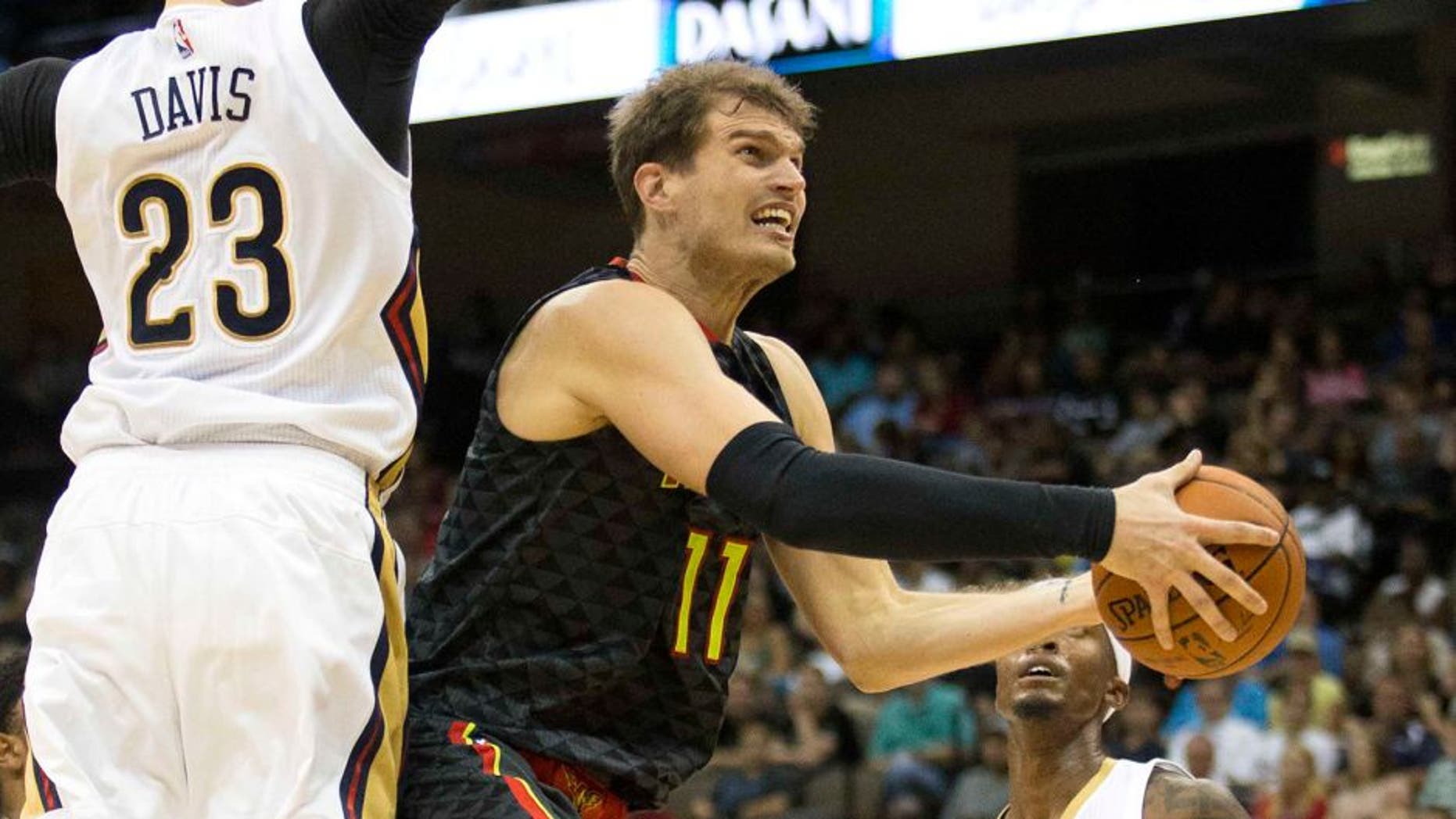Oct 9, 2015; Jacksonville, FL, USA; New Orleans Pelicans forward Anthony Davis (23) defends Atlanta Hawks forward Tiago Splitter (11) during the second quarter at Veterans Memorial Arena. Mandatory Credit: Logan Bowles-USA TODAY Sports