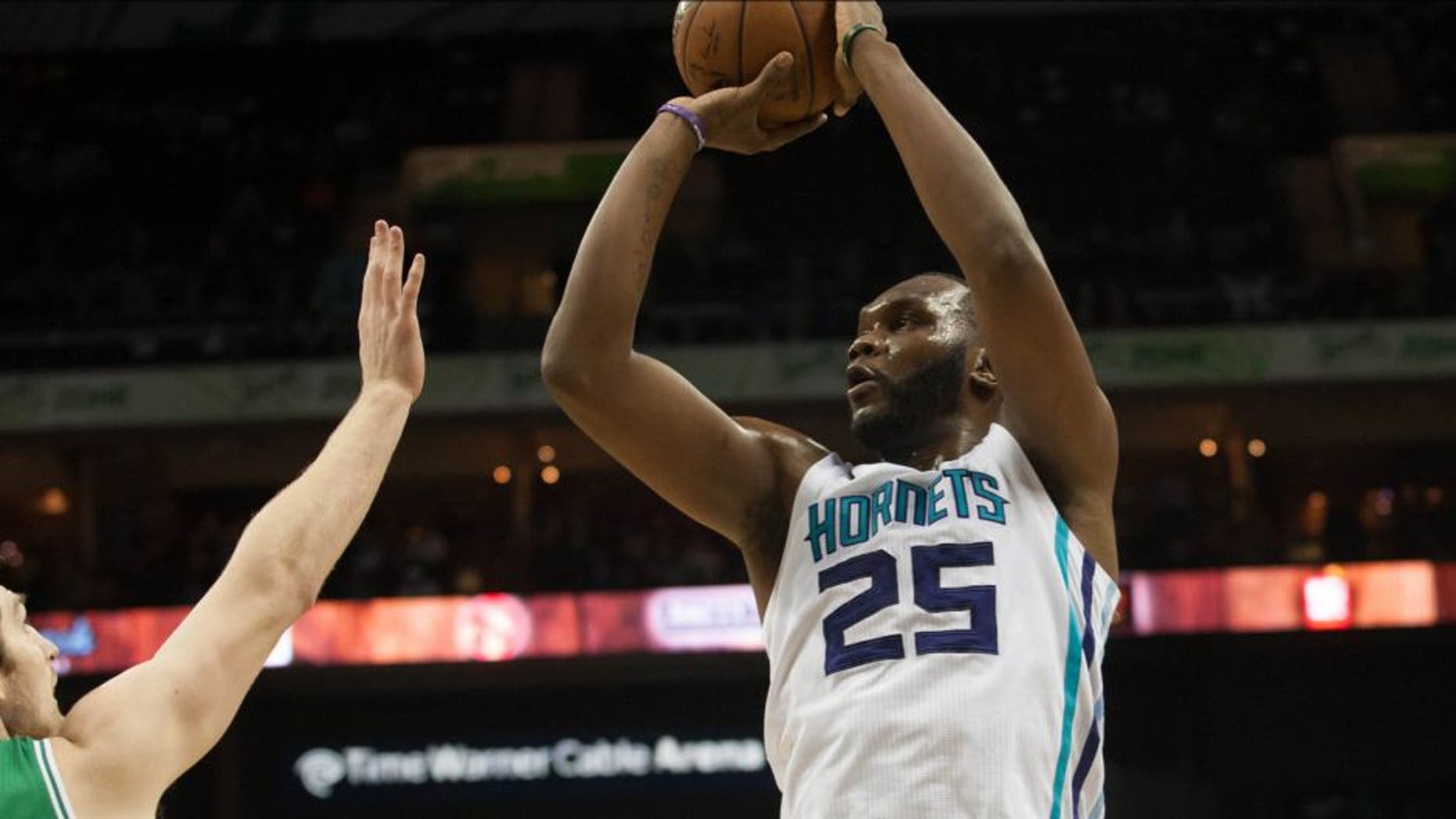 Mar 30, 2015; Charlotte, NC, USA; Charlotte Hornets center Al Jefferson (25) shoots the ball over Boston Celtics center Tyler Zeller (44) during the first half at Time Warner Cable Arena. Mandatory Credit: Jeremy Brevard-USA TODAY Sports