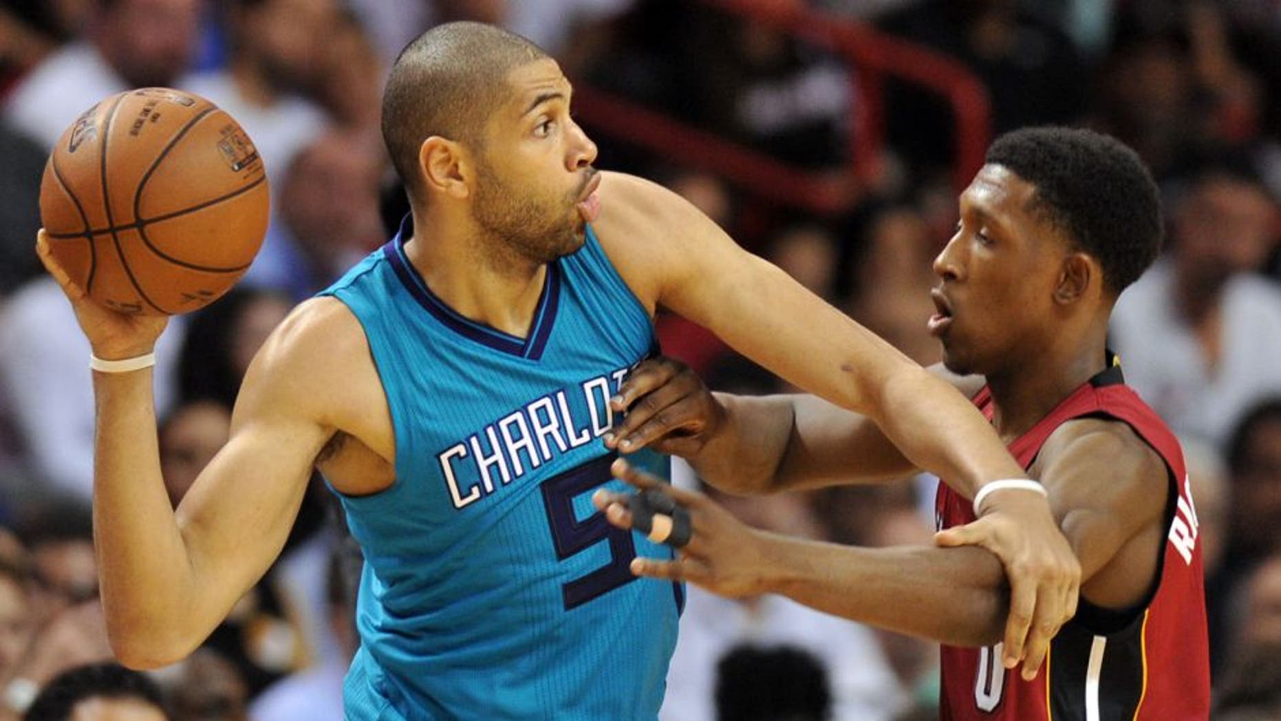 Mar 17, 2016; Miami, FL, USA; Miami Heat guard Josh Richardson (0) applies pressure to Charlotte Hornets guard Nicolas Batum (5) during the second half at American Airlines Arena. Mandatory Credit: Steve Mitchell-USA TODAY Sports
