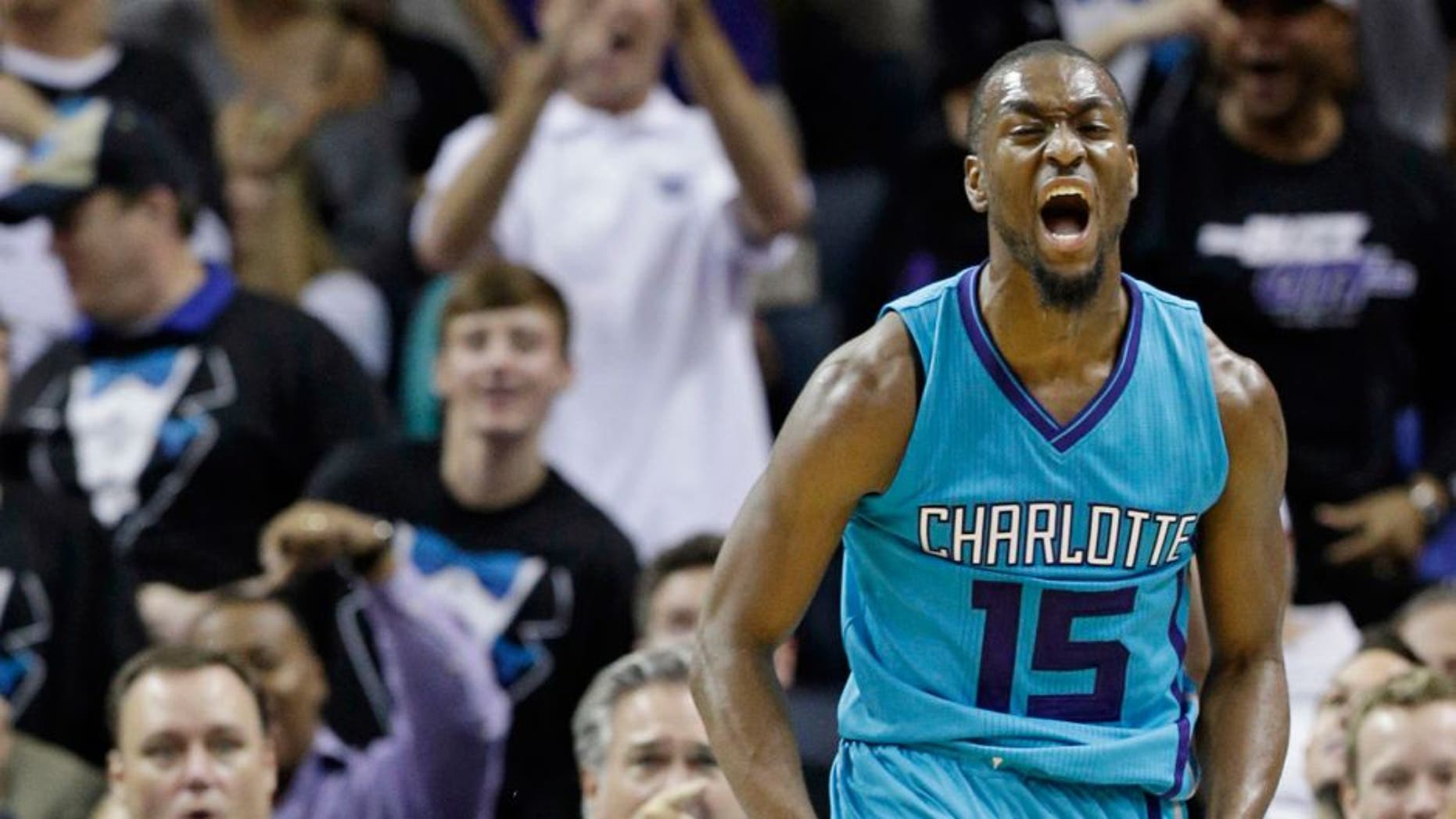 Charlotte Hornets' Kemba Walker (15) reacts after making a basket against the Milwaukee Bucks during the second half of an NBA basketball game in Charlotte, N.C., Wednesday, Oct. 29, 2014. The Hornets won 108-106 in overtime. (AP Photo/Chuck Burton)