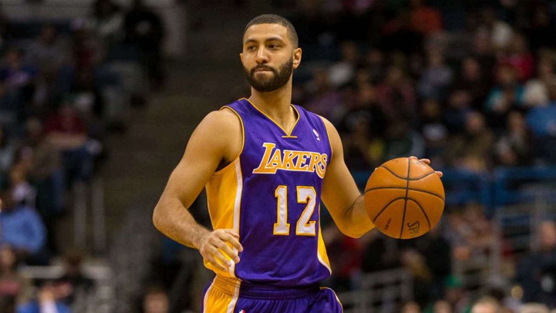 Mar 27, 2014; Milwaukee, WI, USA; Los Angeles Lakers guard Kendall Marshall (12) during the game against the Milwaukee Bucks at BMO Harris Bradley Center. Milwaukee won 108-105.