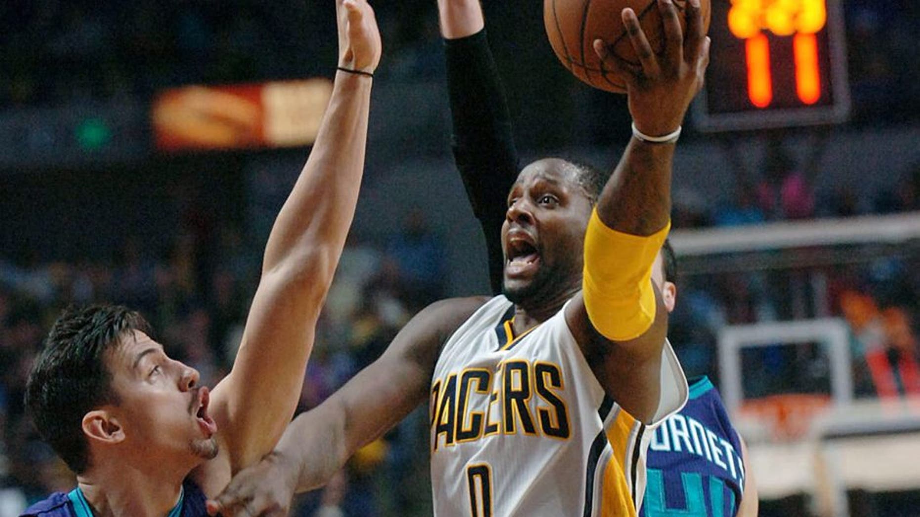 Indiana Pacers' C.J. Miles (0) drives between Charlotte Hornets' Jason Washburn, left, and Frank Kaminsky during the second half of an NBA preseason basketball game, Thursday, Oct. 22, 2015 in Fort Wayne, Ind. (Samuel Hoffman/The Journal-Gazette via AP) NEWS-SENTINEL OUT; MANDATORY CREDIT; NO SALES; MAGS OUT