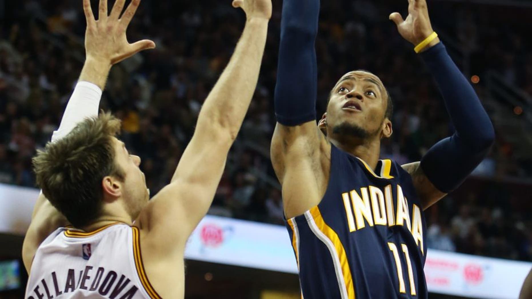 Indiana Pacers guard Monta Ellis (11) shoots over Cleveland Cavaliers guard Matthew Dellavedova (8) during the first half of an NBA basketball game, Sunday, Nov. 8, 2015, in Cleveland. (AP Photo/Ron Schwane)