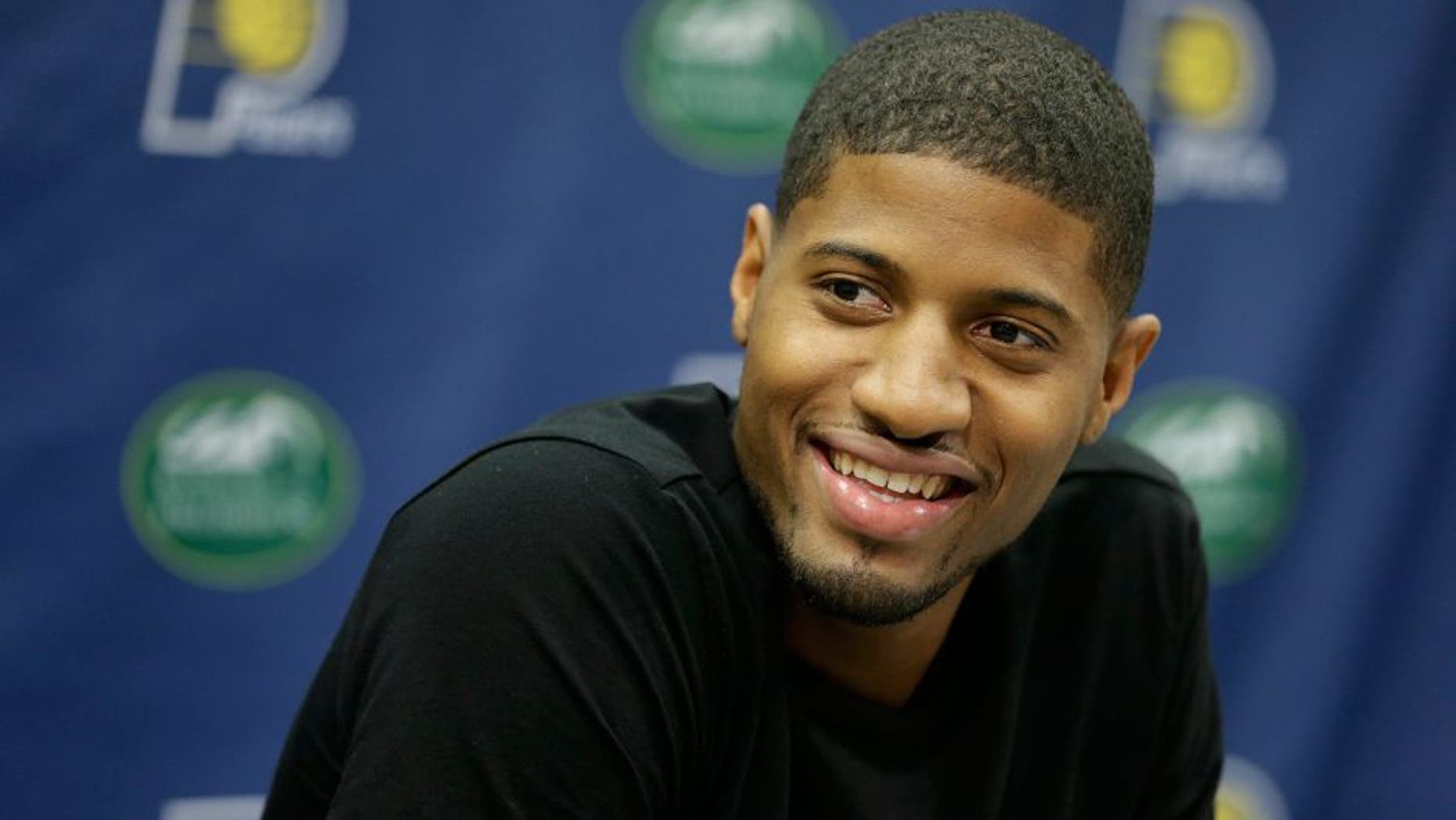 Indiana Pacers' Paul George responds to a question during a news conference Friday, Aug. 15, 2014, in Indianapolis. George hopes to make it back on the court next season despite the "freak accident" that caused a compound fracture in his right leg. (AP Photo/Darron Cummings)