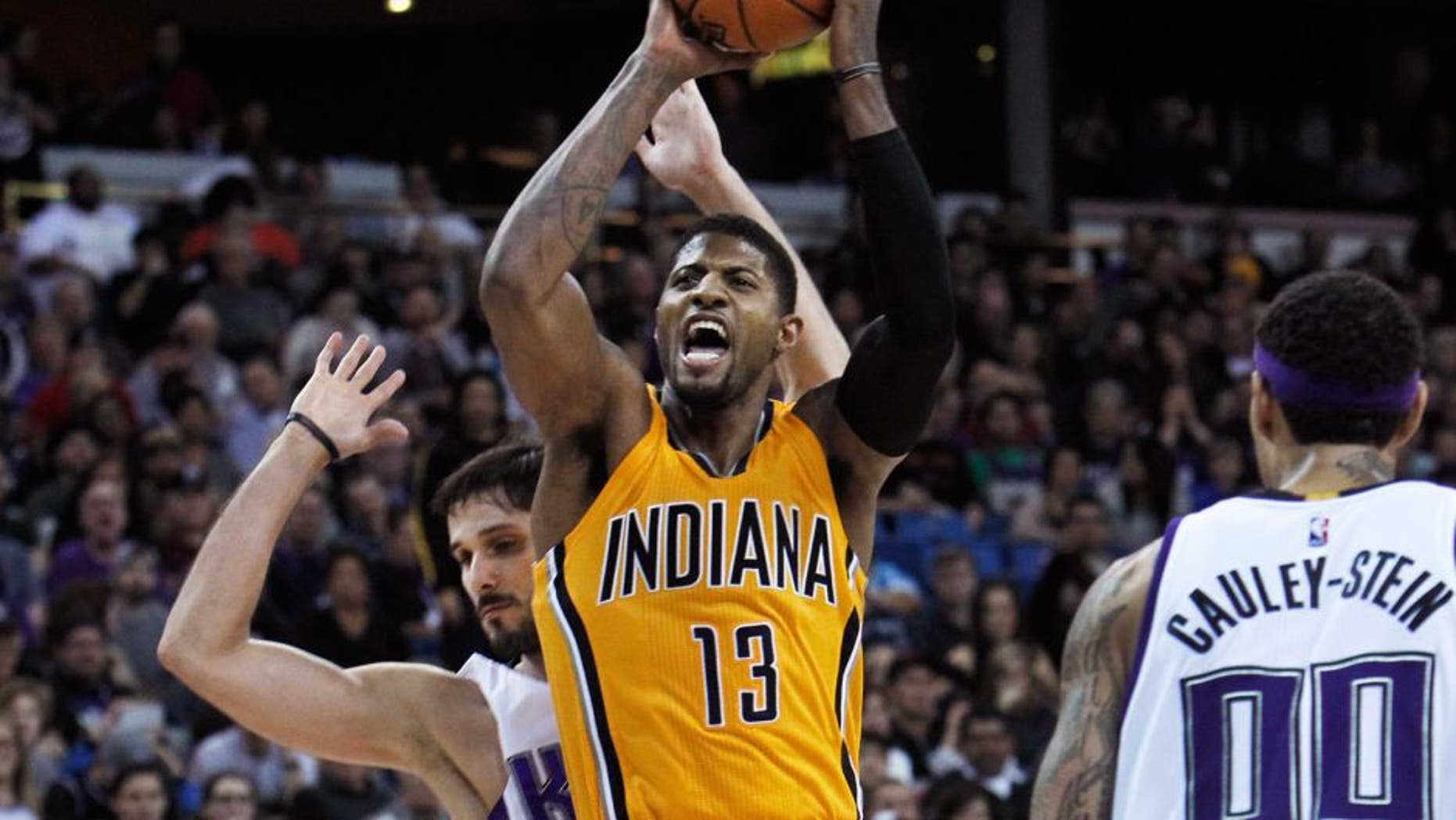 Indiana Pacers forward Paul George (13) is fouled by Sacramento Kings defender Omri Casspi, rear, during the second half of an NBA basketball game in Sacramento, Calif., on Saturday, Jan. 23, 2016. The Kings won 108-97. (AP Photo/Steve Yeater)