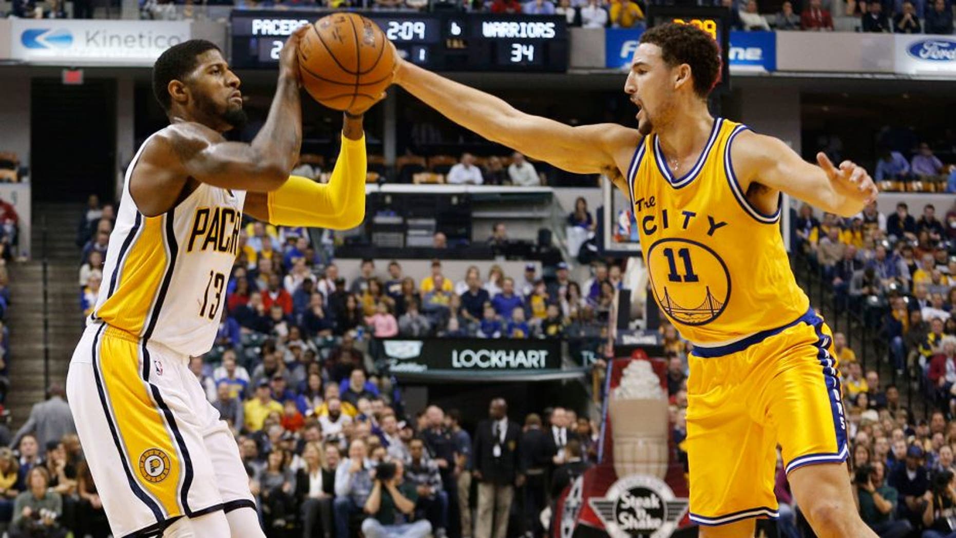 Dec 8, 2015; Indianapolis, IN, USA; Indiana Pacers forward Paul George (13) is guarded by Golden State Warriors guard Klay Thompson (1) at Bankers Life Fieldhouse. Mandatory Credit: Brian Spurlock-USA TODAY Sports