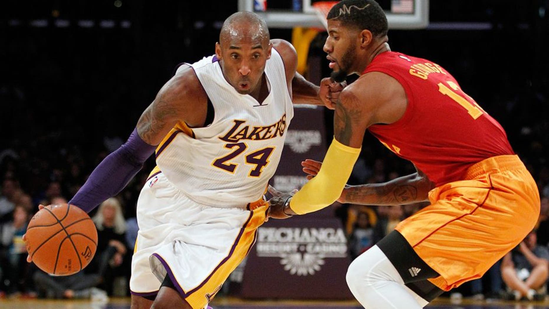 Los Angeles Lakers forward Kobe Bryant (24) drives against Indiana Pacers forward Paul George, right, during the first half of an NBA basketball game in Los Angeles, Sunday, Nov. 29, 2015. (AP Photo/Alex Gallardo)