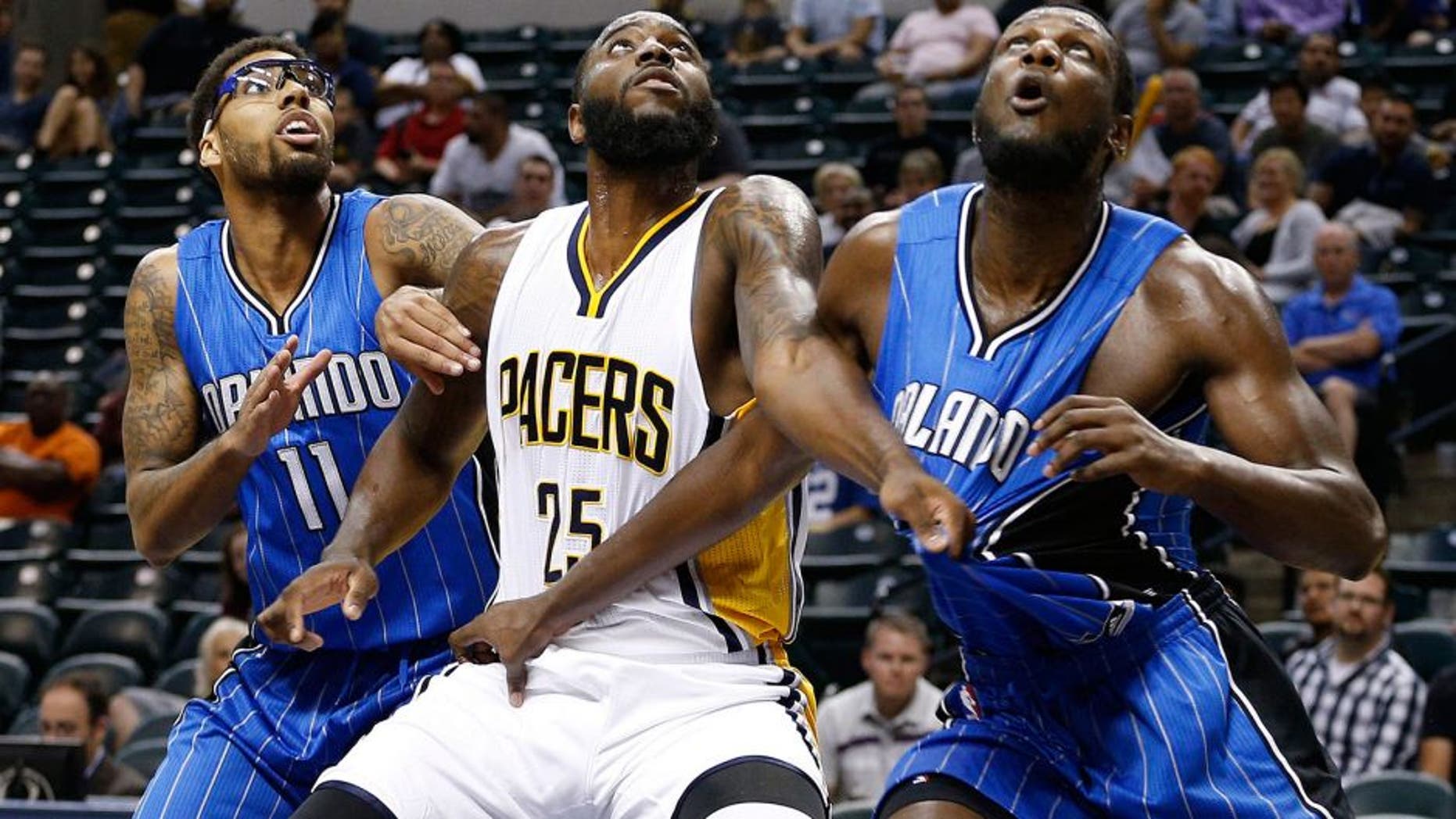Oct 8, 2015; Indianapolis, IN, USA; Indiana Pacers forward Rakeem Christmas (25) battles for position with Orlando Magic center Nnanna Egwu (21) and forward Devyn Marble (11) at Bankers Life Fieldhouse. The Pacers won 97-92. Mandatory Credit: Brian Spurlock-USA TODAY Sports