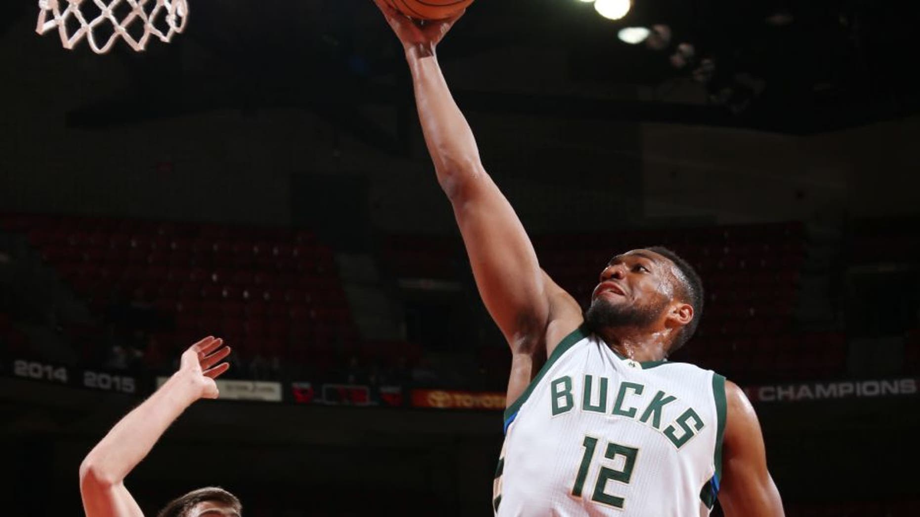 Jabari Parker of the Milwaukee Bucks goes up for a lay up during a preseason game against the Dallas Mavericks.