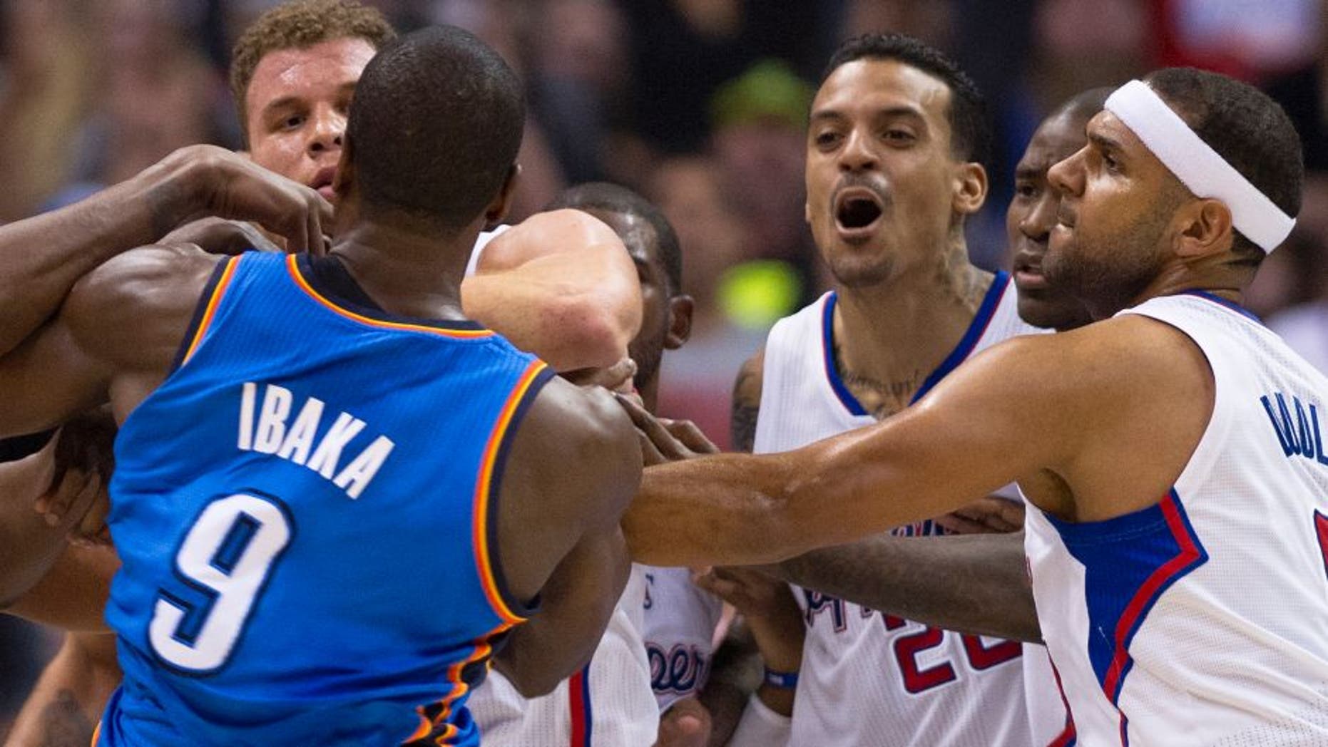 Los Angeles Clippers Matt Barnes (2R) and Oklahoma City Thunder Serge Ibaka (L) skirmish in the final seconds of the second quarter, during NBA action, November 13, 2013 in Los Angeles, California. At far left is the Clippers Blake Griffin and at right is the Clippers Jared Dudley. The Los Angeles Times reported November 14, 2013 that in the final seconds of the second quarter of Wednesday's game between the Clippers and the Oklahoma City Thunder, Blake Griffin and Serge Ibaka got their arms entangled while trying to grab a rebound. They wrestled for a few seconds, then Matt Barnes intervened and shoved Ibaka, who responded by trying to push Barnes while apparently preparing to throw a punch. After Barnes left the court, he sent this tweet from the locker room, which was later taken down because it included an epithet and a curse word: "I love my teammates like family, but I'm DONE standing up for these ...! All this ... does is cost me money." Doc Rivers said he was disappointed by Barnes' words after the Clippers secured a 111-103 victory at Staples Center. AFP PHOTO / Robyn Beck (Photo credit should read ROBYN BECK/AFP/Getty Images)