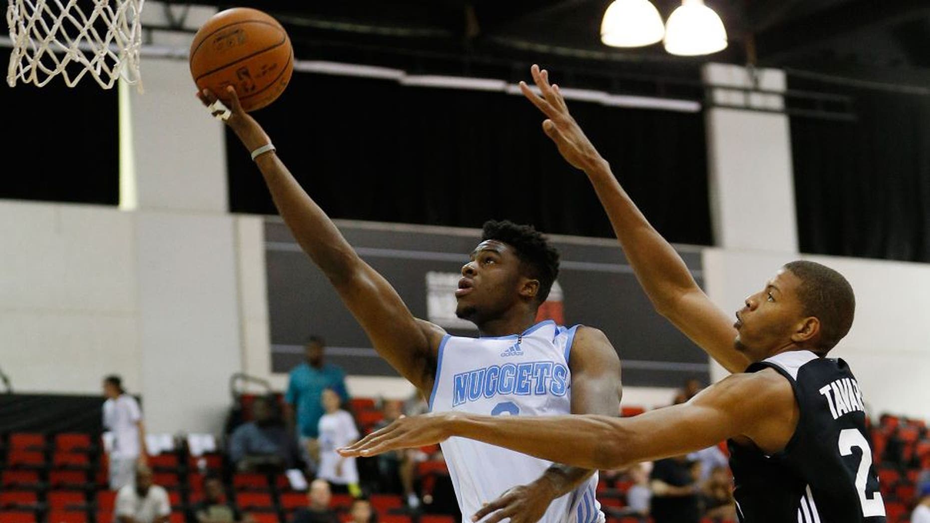 Denver Nuggets' Emmanuel Mudiay, left, goes up for a shot against the Atlanta Hawks' Walter Tavares during the first half of an NBA summer league basketball game Friday, July 10, 2015, in Las Vegas. (AP Photo/John Locher)