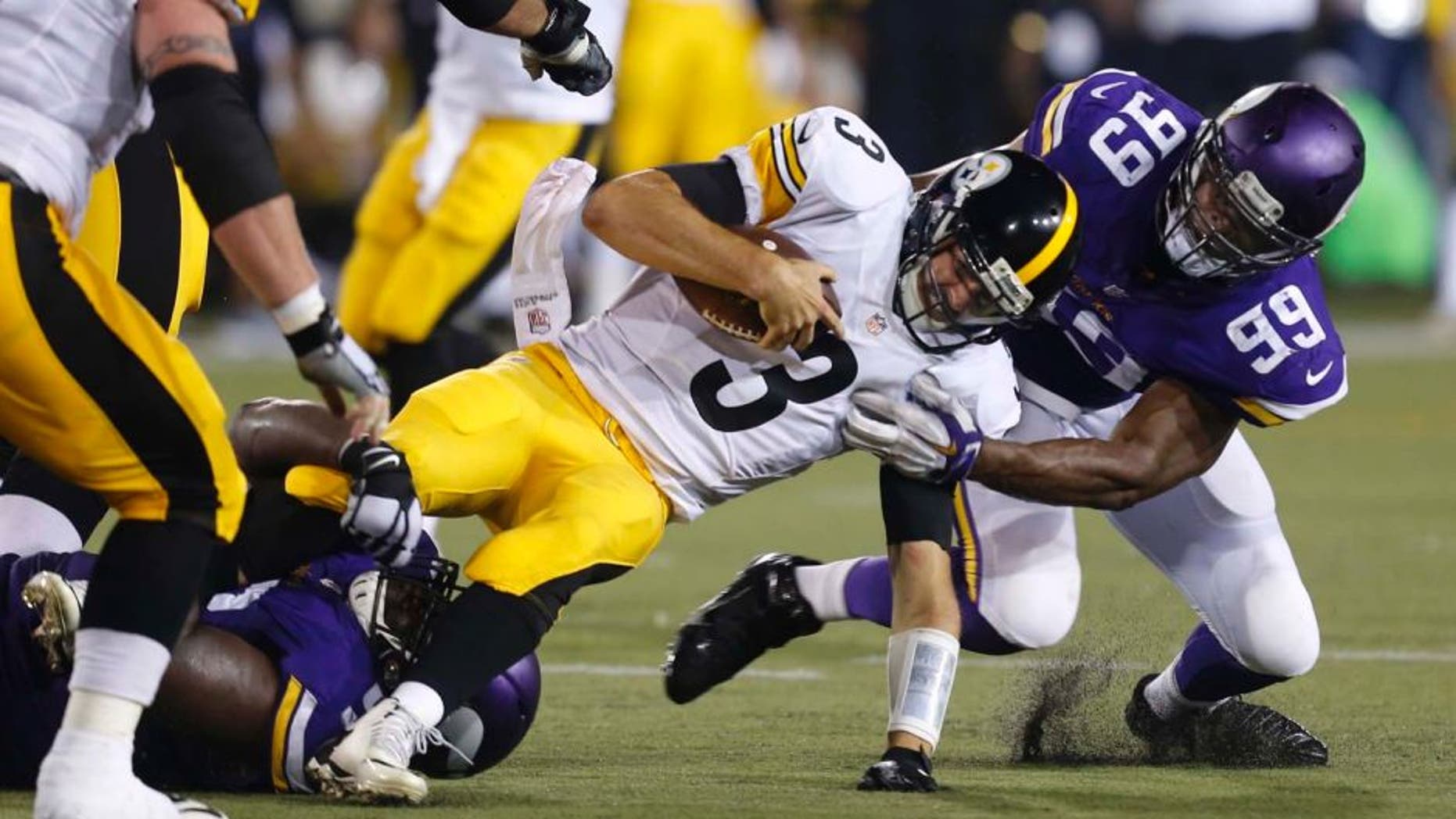 Pittsburgh Steelers quarterback Landry Jones is tackled by Minnesota Vikings defensive end Danielle Hunter (right) and defensive tackle Shamar Stephen (bottom left) after scrambling for a short gain during the second half of an NFL preseason football game in Canton, Ohio, on Sunday, August 9, 2015.