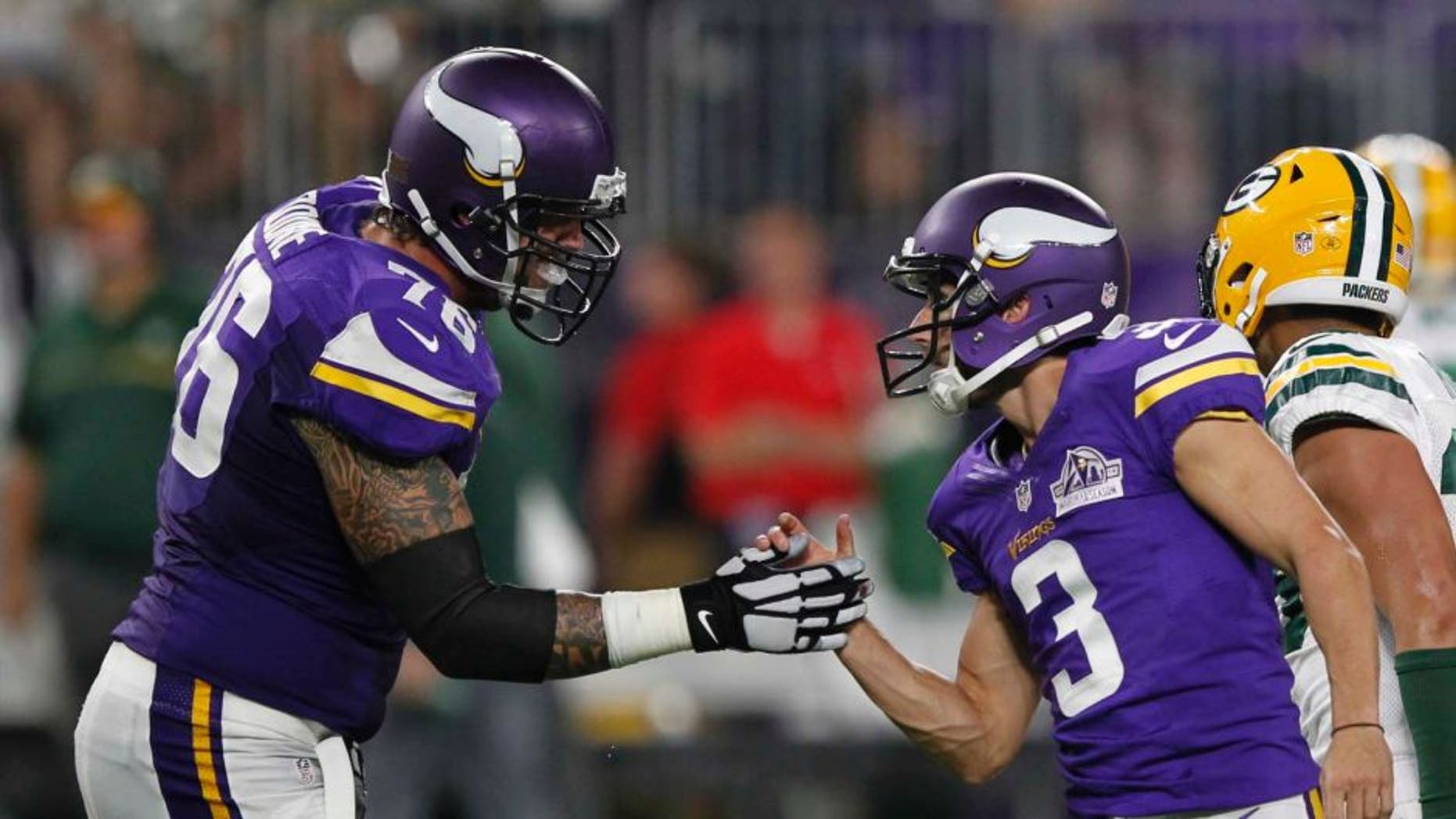 Minnesota Vikings kicker Blair Walsh (right) celebrates with teammate Alex Boone after kicking a 46-yard field goal during the first half against the Green Bay Packers on Sunday, Sept. 18, 2016, in Minneapolis.