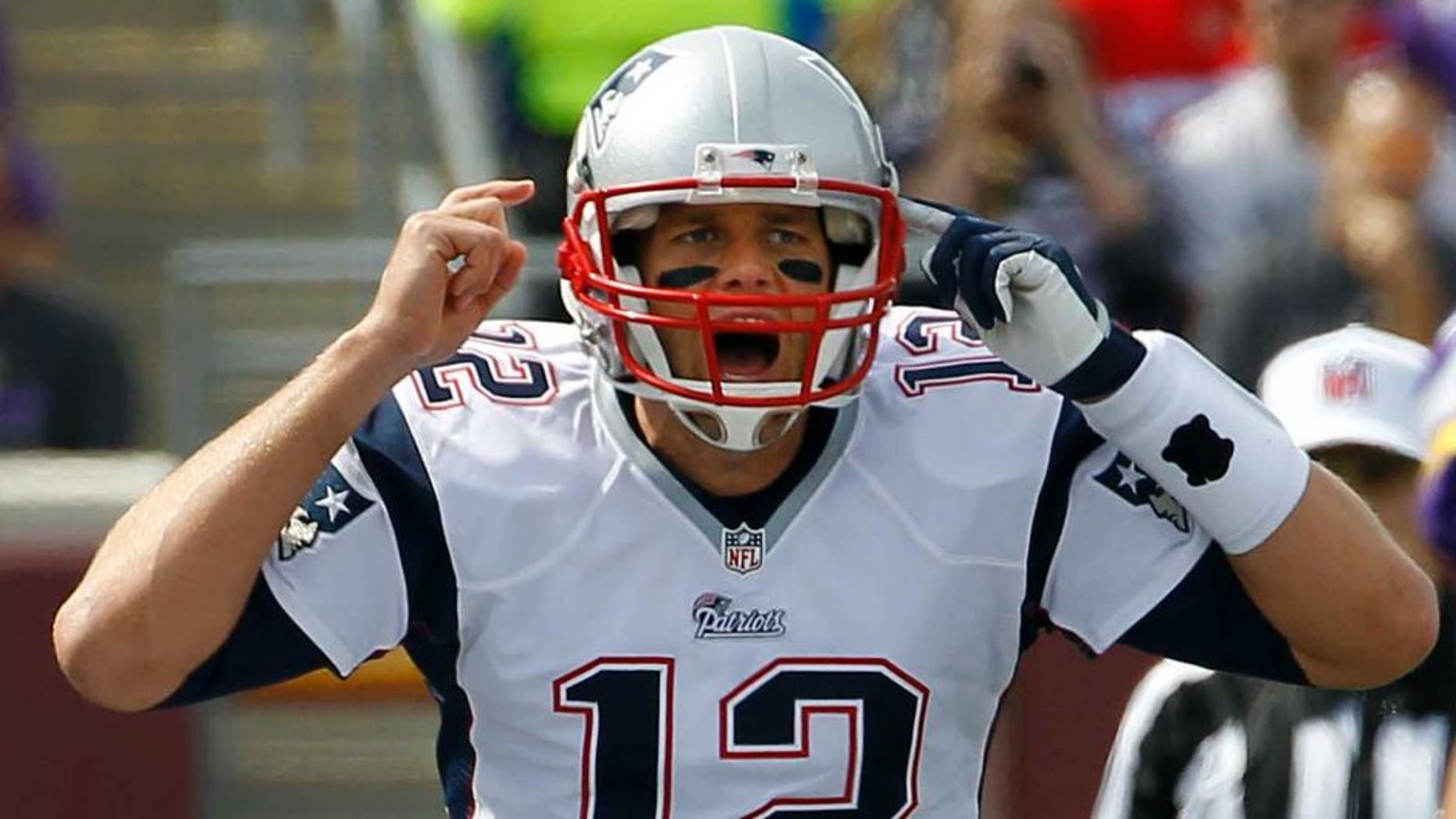 New England Patriots quarterback Tom Brady yells on the line of scrimmage during the first quarter.