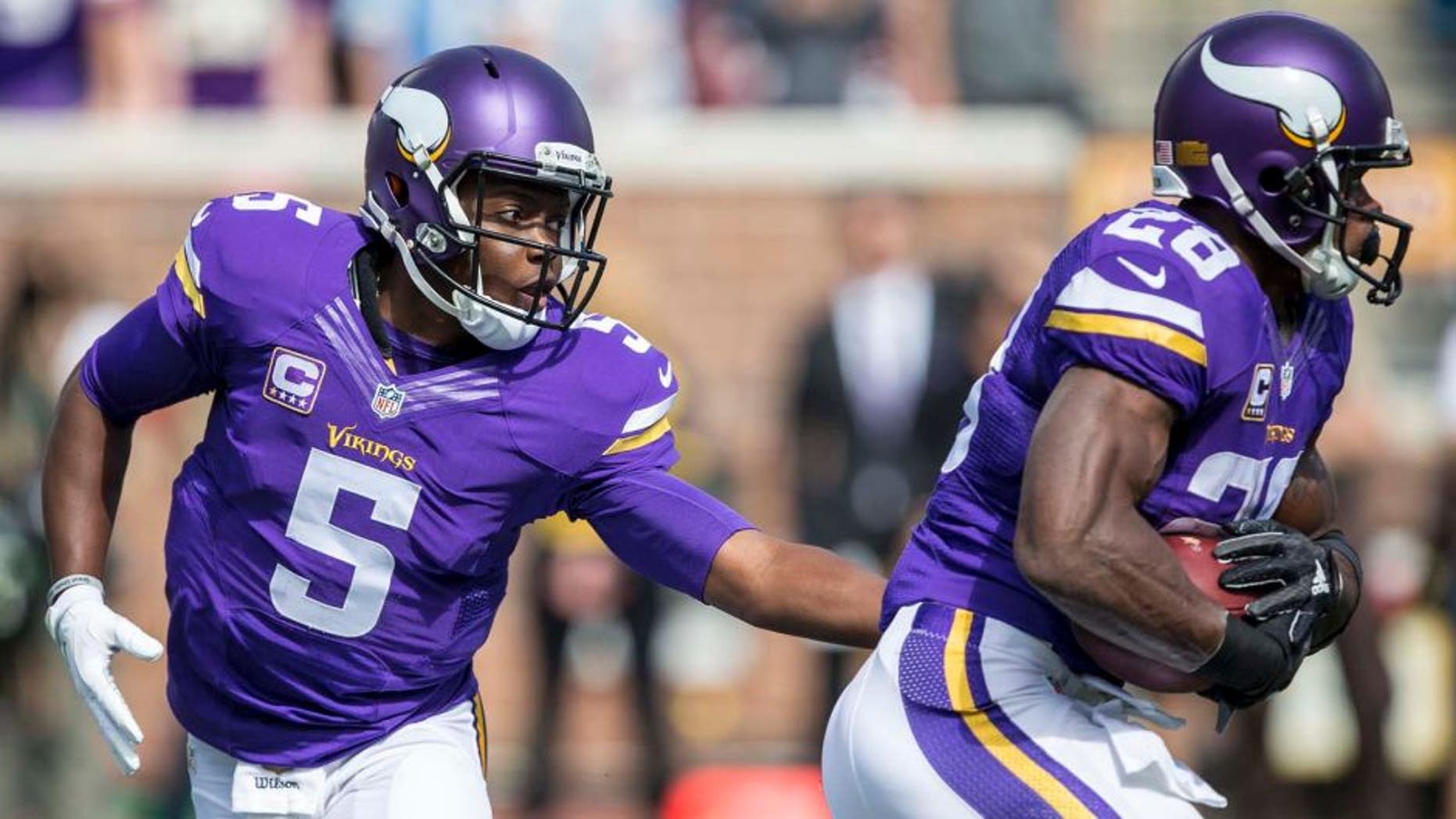 Minnesota Vikings quarterback Teddy Bridgewater hands the ball off to running back Adrian Peterson in the first half at TCF Bank Stadium in Minneapolis on Sunday, Sept. 20, 2015.