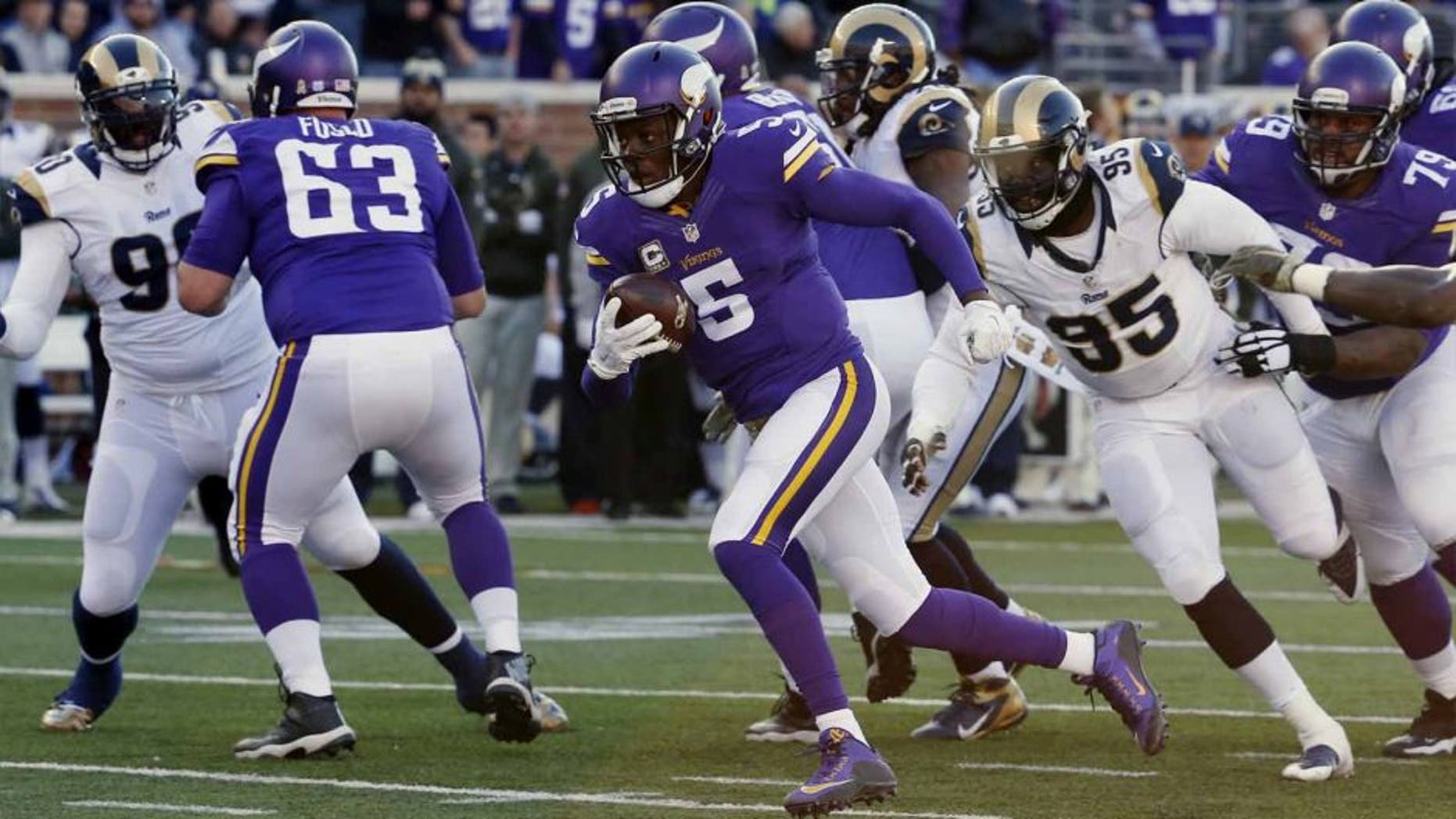Minnesota Vikings quarterback Teddy Bridgewater breaks away from St. Louis Rams defensive end William Hayes for a touchdown run during the second half of an NFL football game Sunday, Nov. 8, 2015, in Minneapolis.