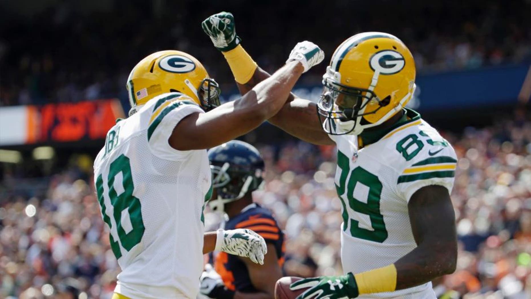Green Bay Packers wide receiver James Jones (right) celebrates his touchdown reception with wide receiver Randall Cobb during the first half of an NFL football game, Sunday, Sept. 13, 2015, in Chicago.