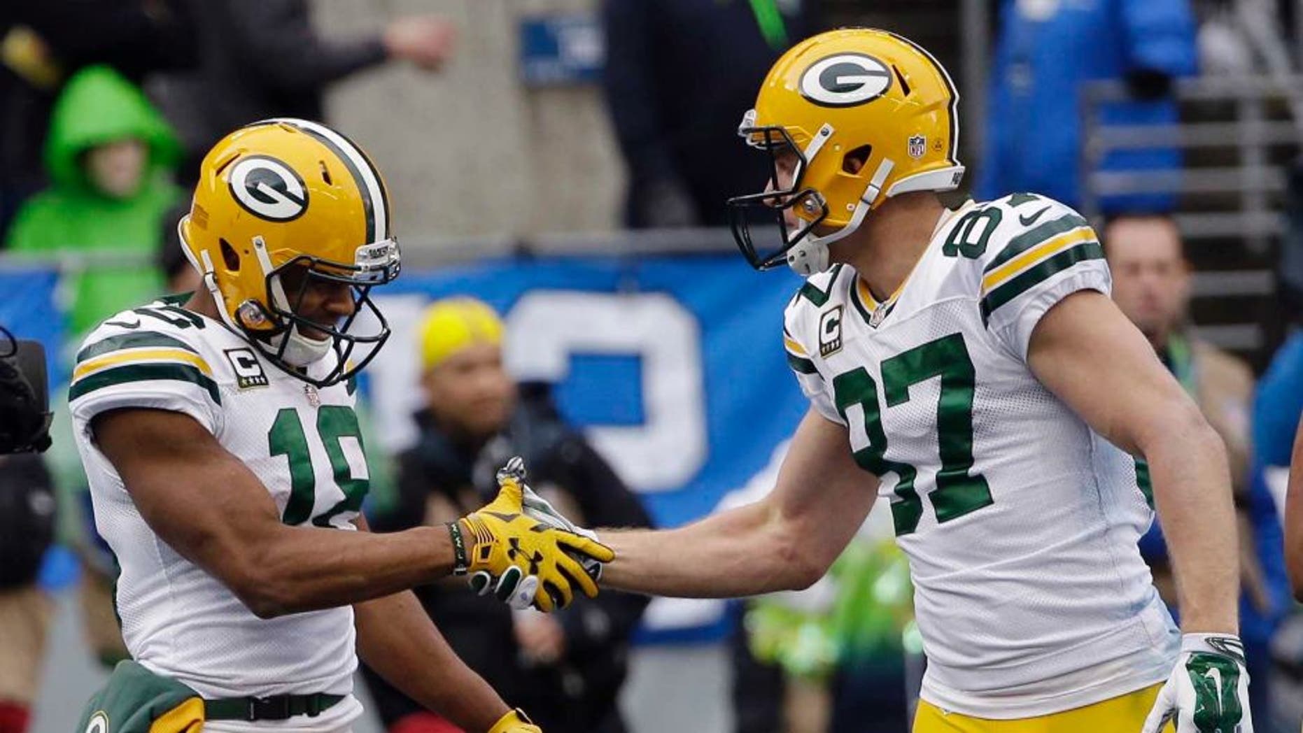 The Green Bay Packers' Randall Cobb (left) celebrates his touchdown catch with Jordy Nelson during the first half of the NFC championship game in Seattle.