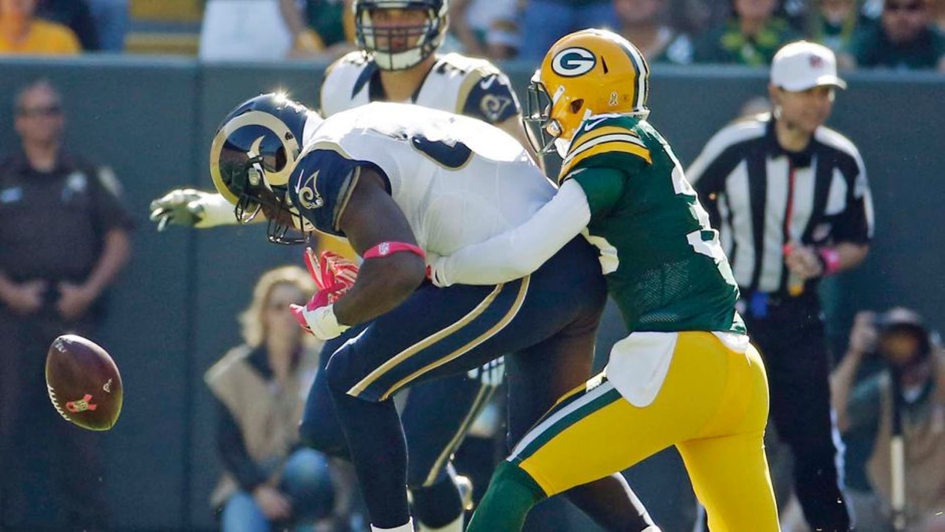 The Green Bay Packers' Micah Hyde breaks up a pass intended for the St. Louis Rams' Jared Cook during the first half Sunday, Oct. 11, 2015, in Green Bay, Wis.