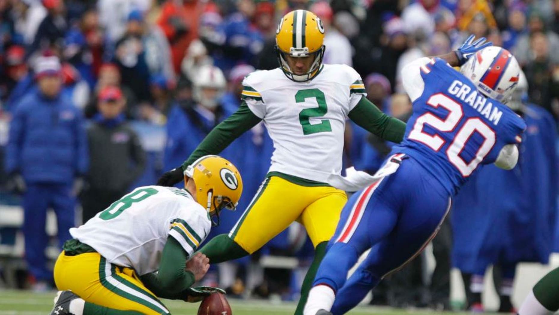 Green Bay Packers kicker Mason Crosby (center) boots a field goal during the first half against the Buffalo Bills.