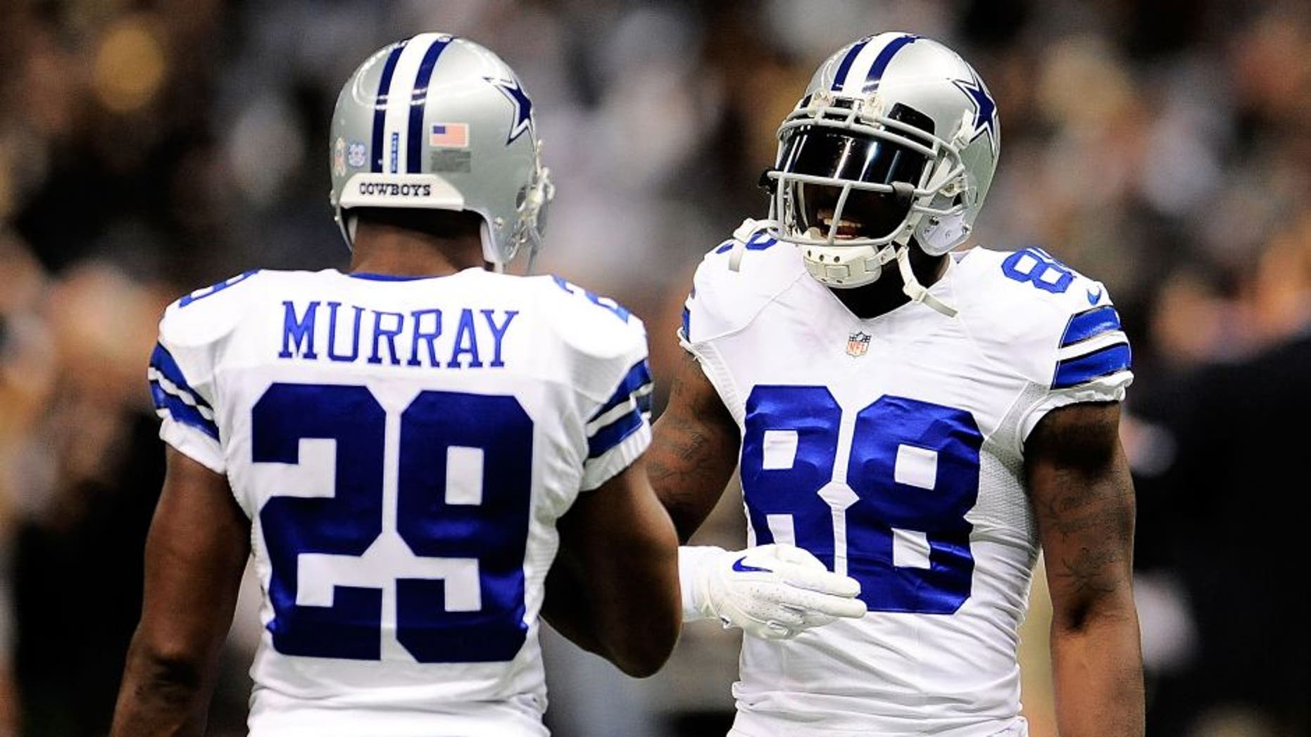 NEW ORLEANS, LA - NOVEMBER 10: DeMarco Murray #29 and Dez Bryant #88 of the Dallas Cowboys meet on the field prior to a game against the New Orleans Saints at the Mercedes-Benz Superdome on November 10, 2013 in New Orleans, Louisiana. New Orleans defeated Dallas 49-17. (Photo by Stacy Revere/Getty Images)