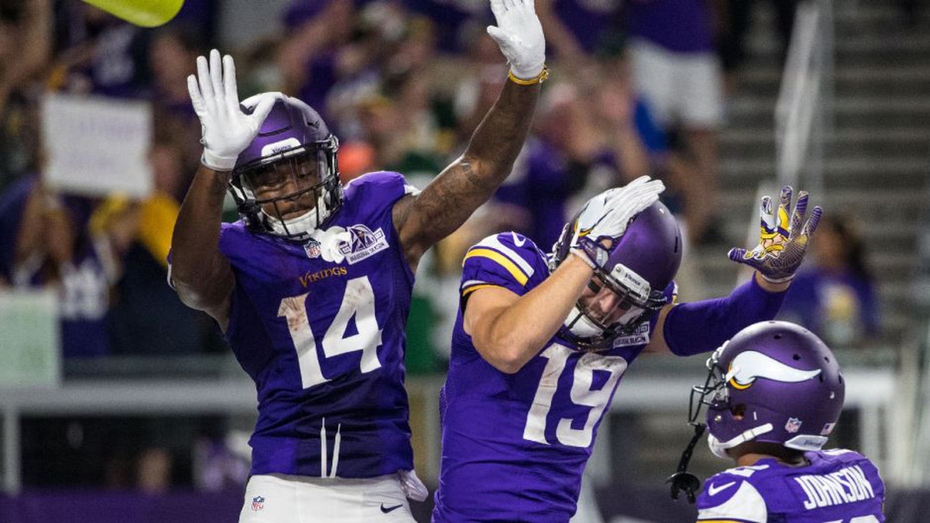 Minnesota Vikings wide receiver Stefon Diggs celebrates his touchdown with wide receiver Adam Thielen during the third quarter against the Green Bay Packers.