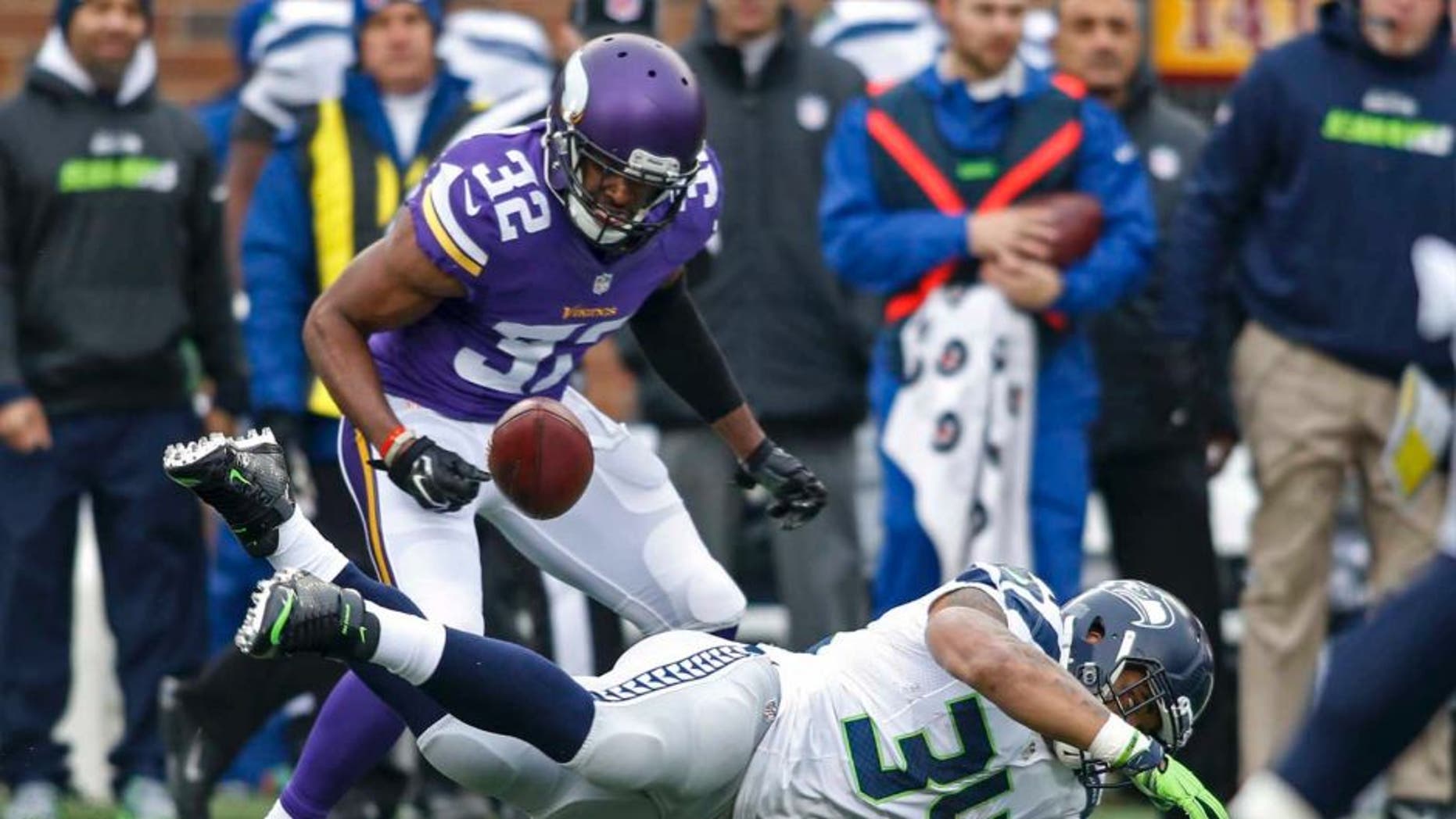 Seattle Seahawks running back Thomas Rawls fumbles the ball and Minnesota Vikings safety Antone Exum Jr. recovers it on a run in the first quarter at TCF Bank Stadium in Minneapolis on Sunday, Dec. 6, 2015.