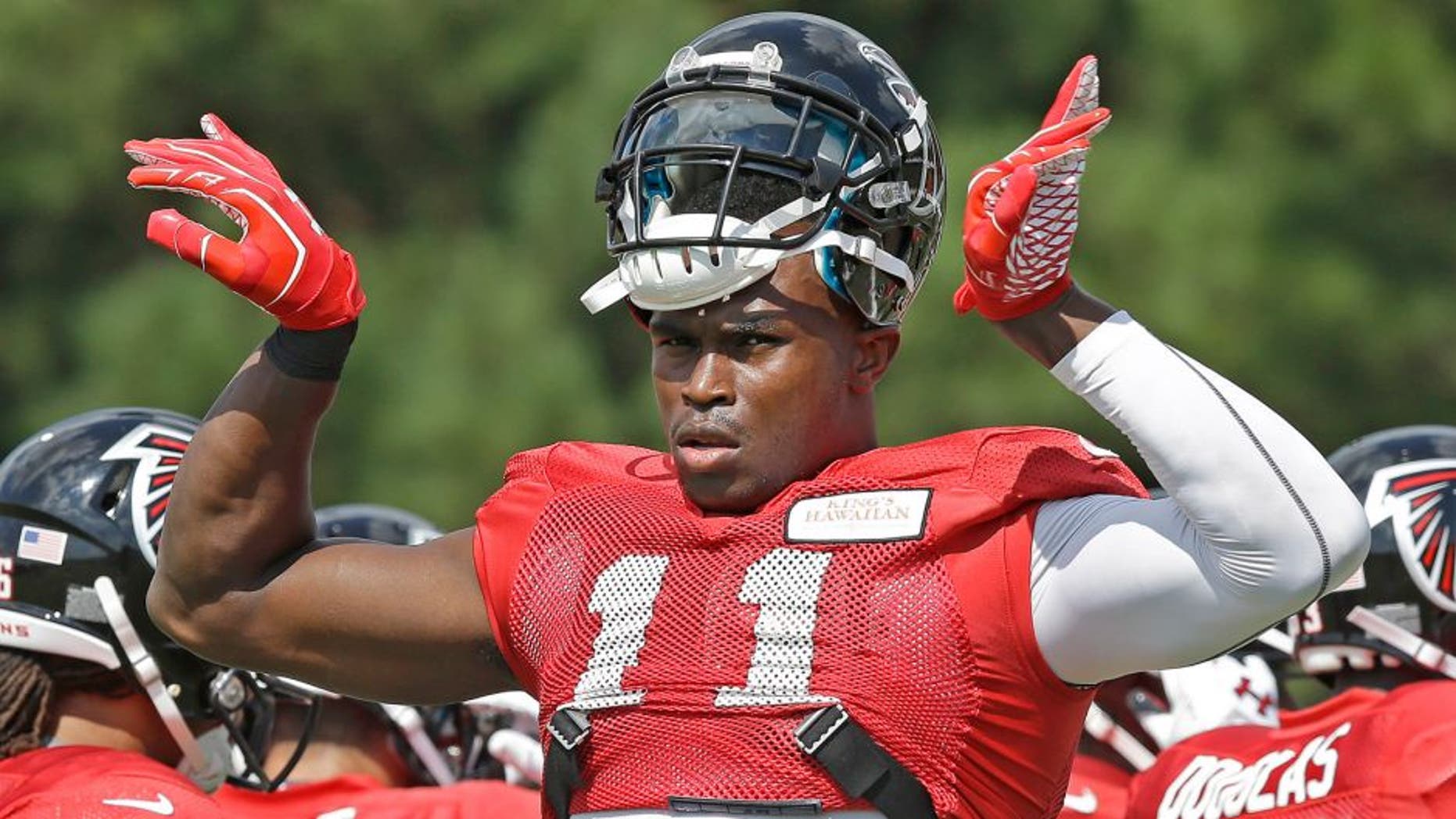 Atlanta Falcons wide receiver Julio Jones (11) gestures during an NFL football training camp Tuesday, July 29, 2014 in Flowery Branch, Ga. (AP Photo/Brynn Anderson)
