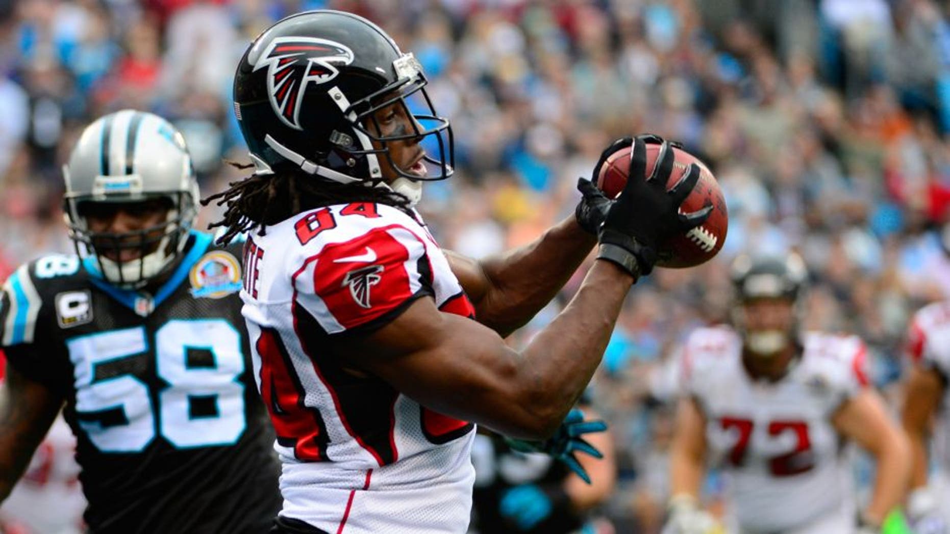 Dec 9, 2012; Charlotte, NC, USA; Atlanta Falcons wide receiver Roddy White (84) makes a touchdown catch as Carolina Panthers outside linebacker Thomas Davis (58) defends in the second half at Bank of America Stadium. Mandatory Credit: Bob Donnan-USA TODAY Sports