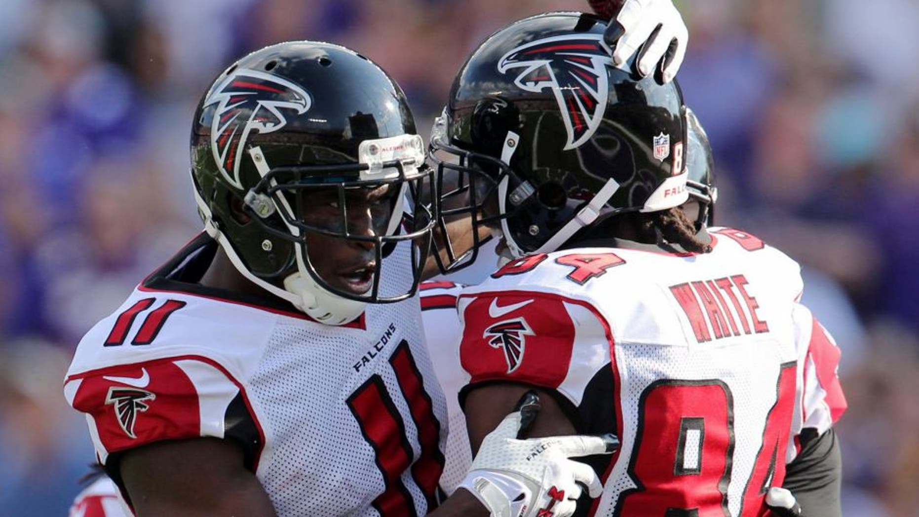 Sep 28, 2014; Minneapolis, MN, USA; Atlanta Falcons wide receiver Roddy White (84) celebrates his touchdown with wide receiver Julio Jones (11) during the first quarter against the Minnesota Vikings at TCF Bank Stadium. Mandatory Credit: Brace Hemmelgarn-USA TODAY Sports