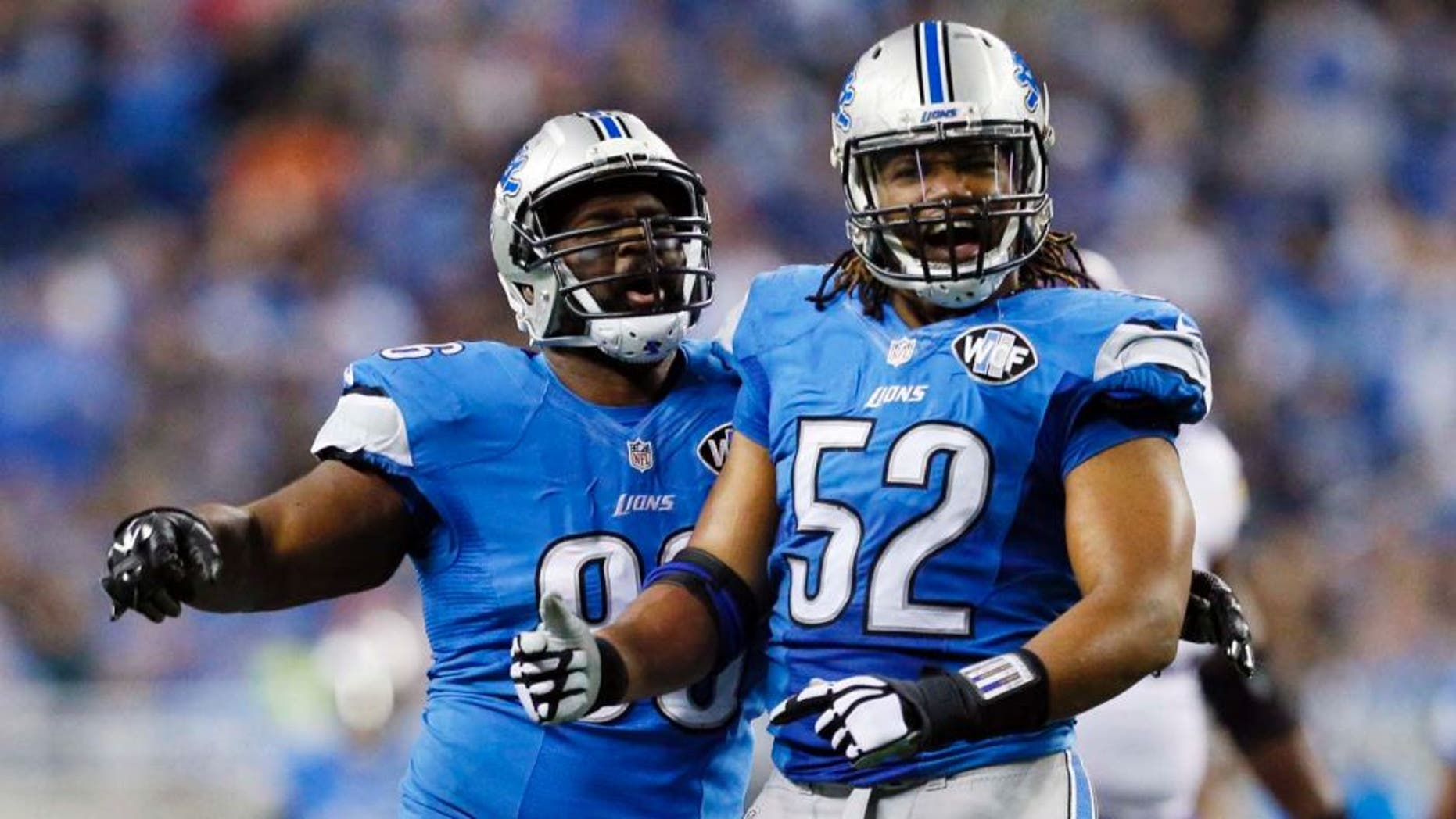Detroit Lions defensive tackle Andre Fluellen (left) and defensive end Darryl Tapp react after their sack of Minnesota Vikings quarterback Teddy Bridgewater during the first half.