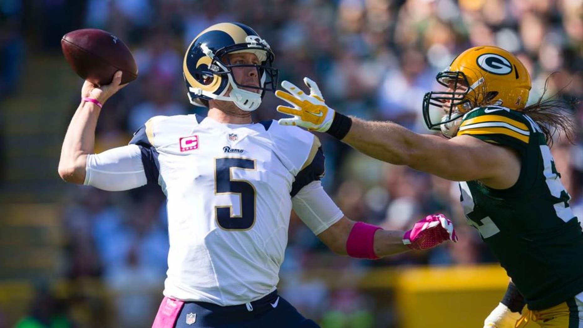 St. Louis Rams quarterback Nick Foles throws a pass under pressure from Green Bay Packers linebacker Clay Matthews during the first quarter at Lambeau Field in Green Bay, Wis., on Sunday, Oct. 11, 2015.