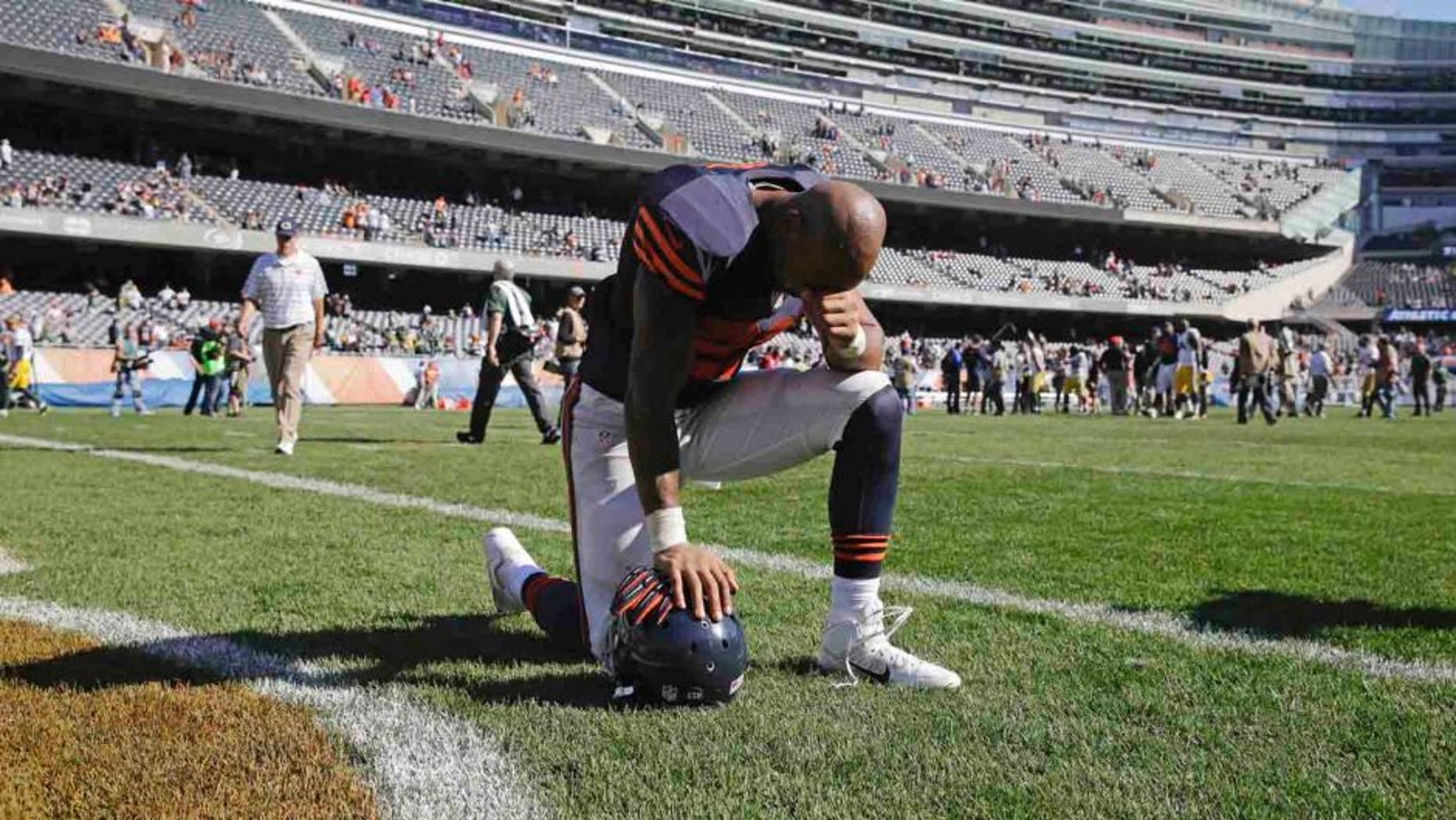 Chicago Bears running back Matt Forte pauses on the field after the Bears' 38-17 loss to the Green Bay Packers.