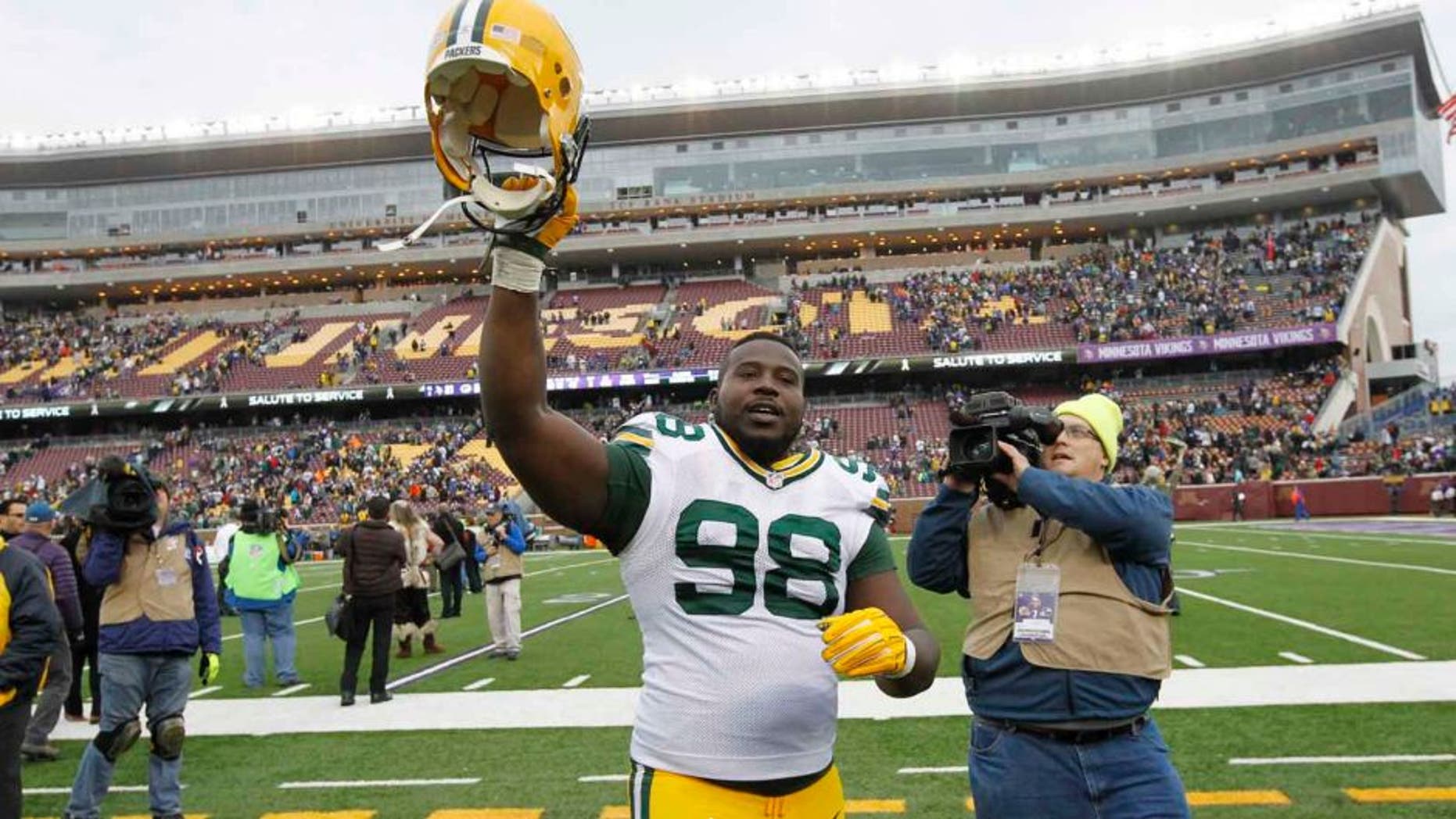 Green Bay Packers nose tackle Letroy Guion celebrates after the Packers' 24-21 win against the Minnesota Vikings in Minneapolis.