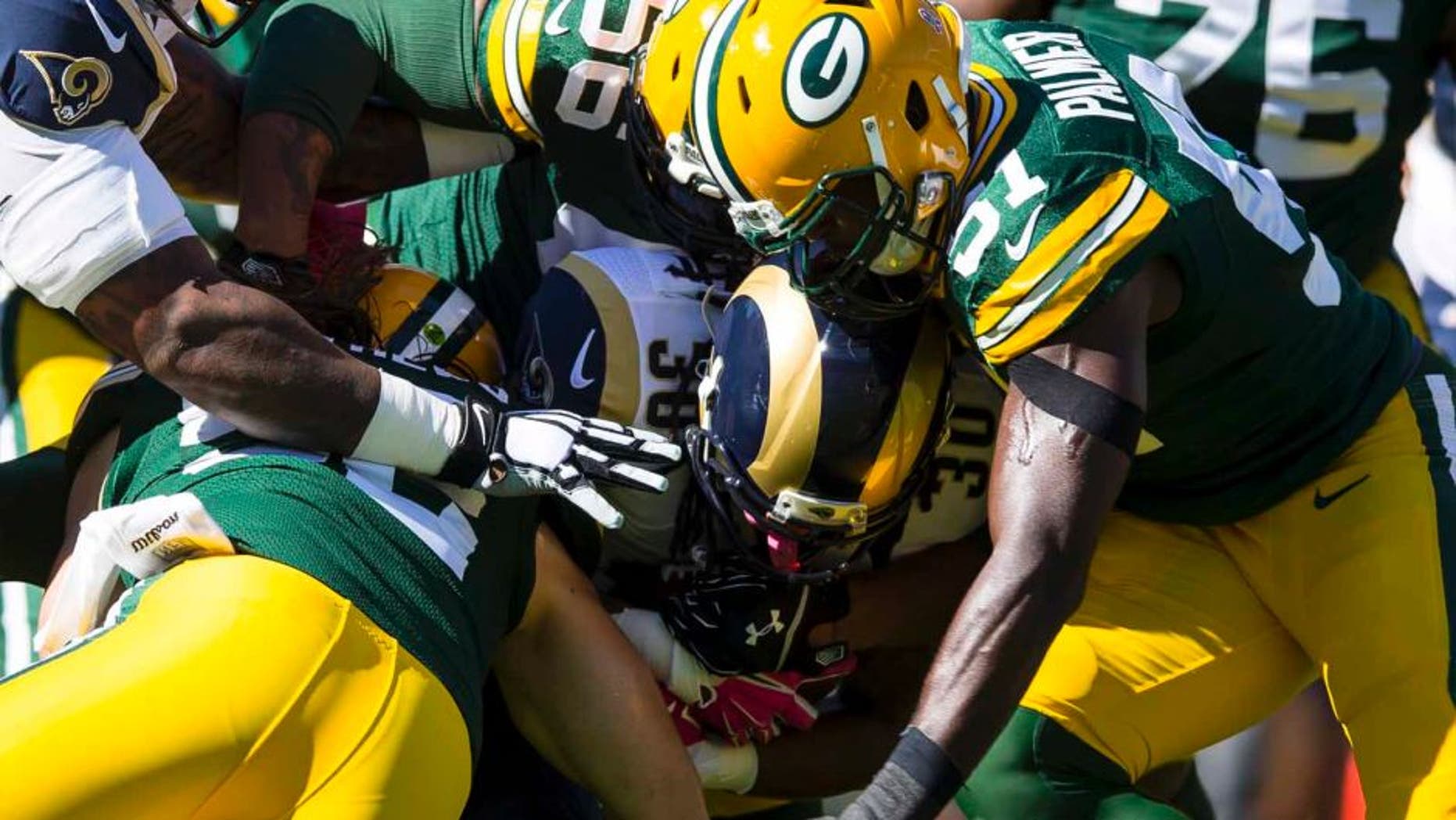 St. Louis Rams running back Todd Gurley is tackled with the football during the first quarter against the Green Bay Packers at Lambeau Field in Green Bay, Wis., on Sunday, Oct. 11, 2015.