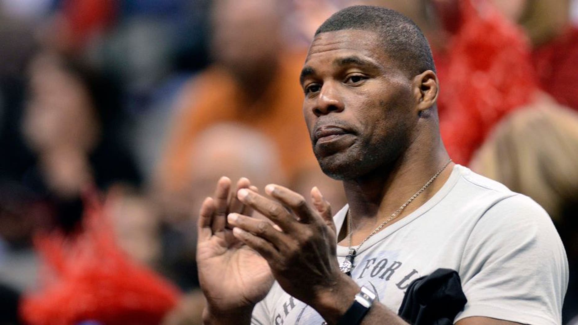 Mar 27, 2011; Dallas, TX, USA; Georgia Bulldogs former football player Herschel Walker cheers during player introductions before their game against the Texas A&M Aggies during the semifinals of the Dallas regional of the 2011 NCAA women's basketball tournament at the American Airlines Center. Mandatory Credit: Matt Strasen-USA TODAY Sports