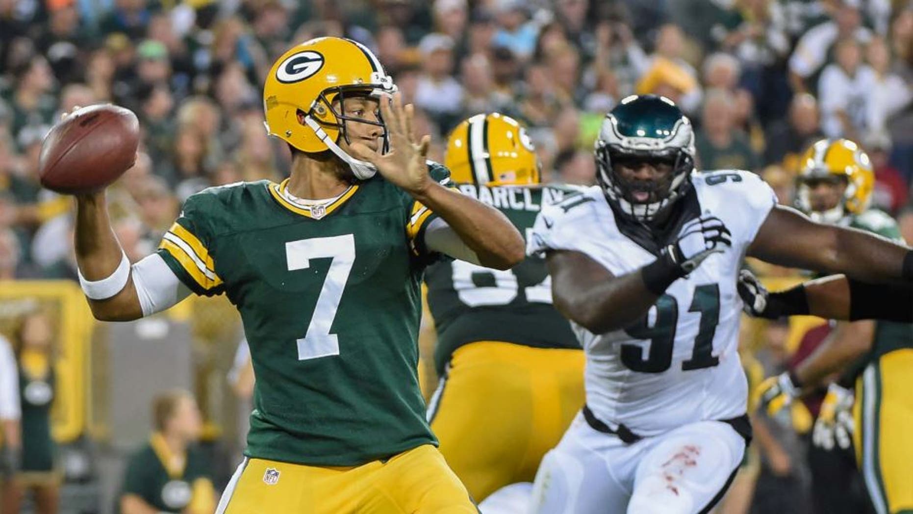 Green Bay Packers quarterback Brett Hundley gets a pass away while under pressure from Philadelphia Eagles defensive end Fletcher Cox in the second quarter of a preseason game at Lambeau Field on Saturday, Aug. 29, 2015.