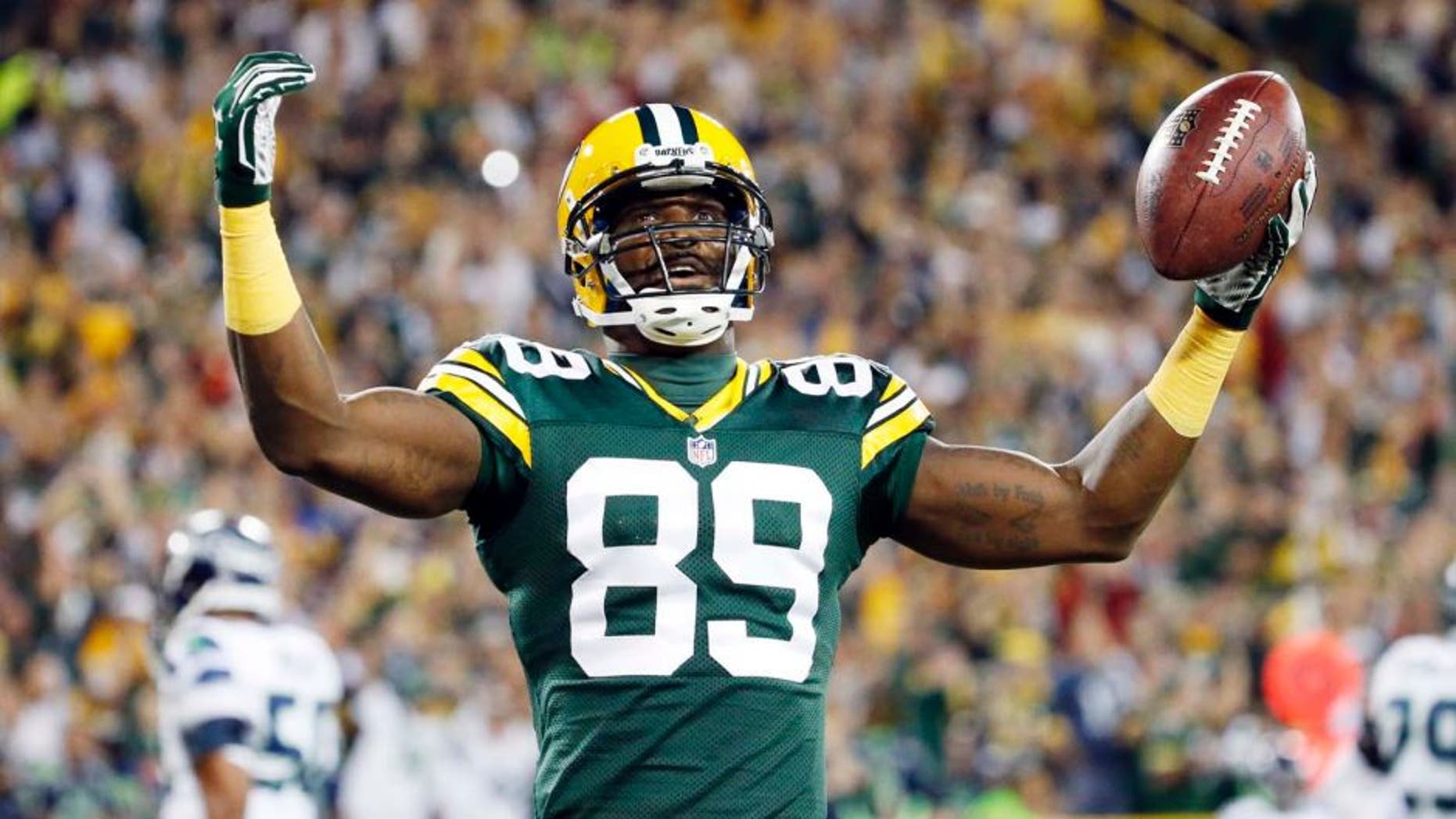 The Green Bay Packers' James Jones celebrates a touchdown catch during the first half of an NFL football game against the Seattle Seahawks on Sunday, Sept. 20, 2015, in Green Bay, Wis.
