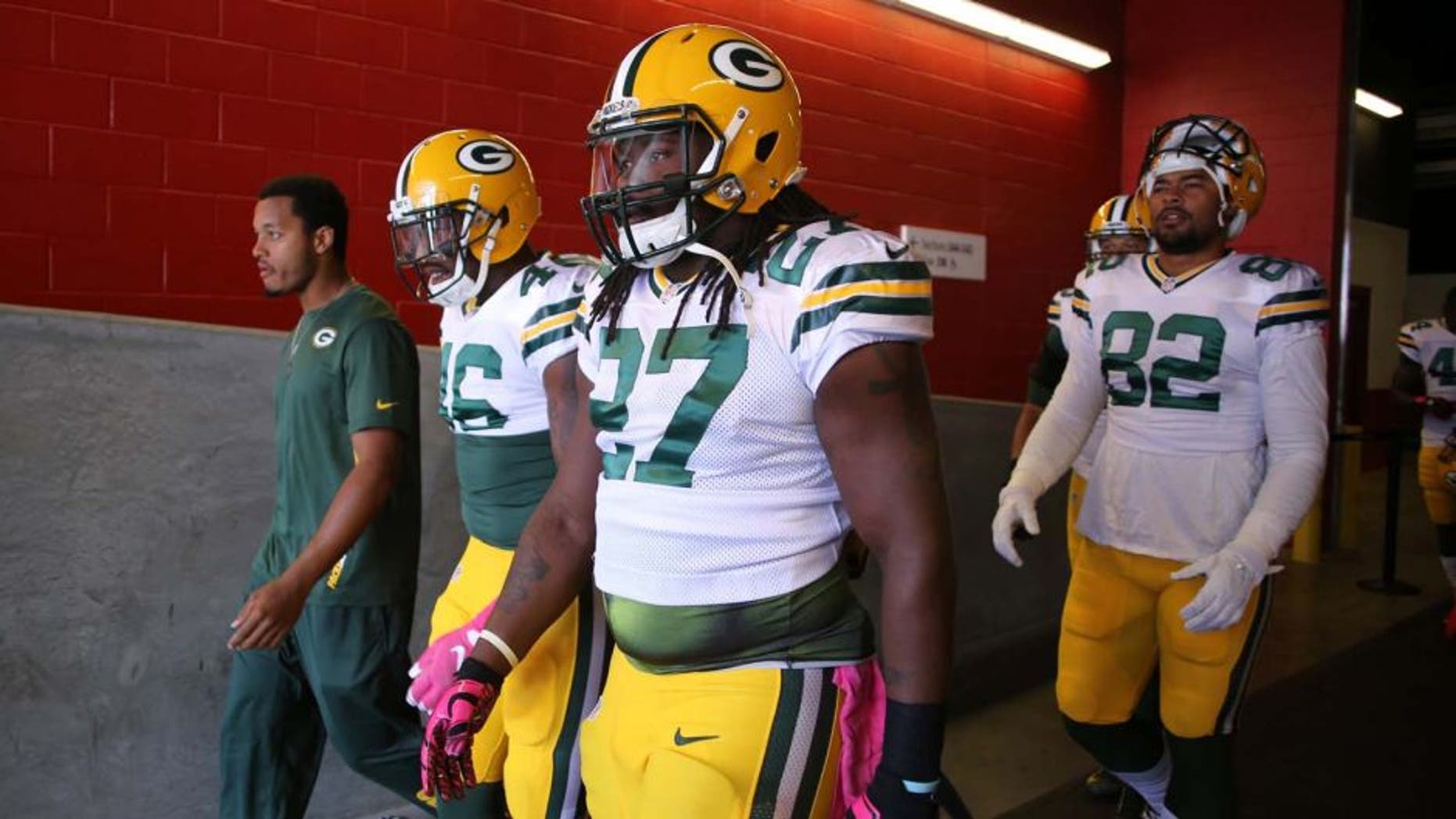 Green Bay Packers running back Eddie Lacy (center) walks towards the field before the start of the game against the San Francisco 49ers at Levi's Stadium in Santa Clara, Calif., on Sunday, Oct. 4, 2015.