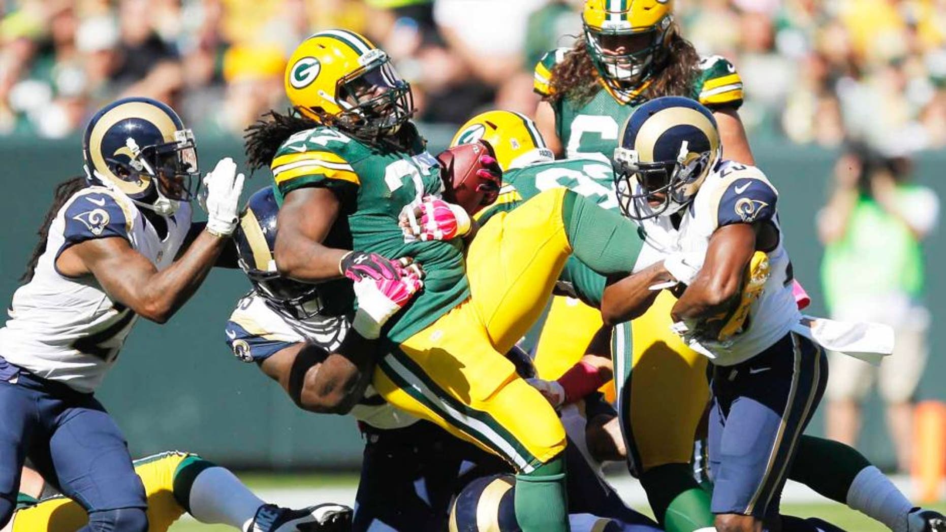 The Green Bay Packers' Eddie Lacy is stopped during the first half against the St. Louis Rams on Sunday, Oct. 11, 2015, in Green Bay, Wis.