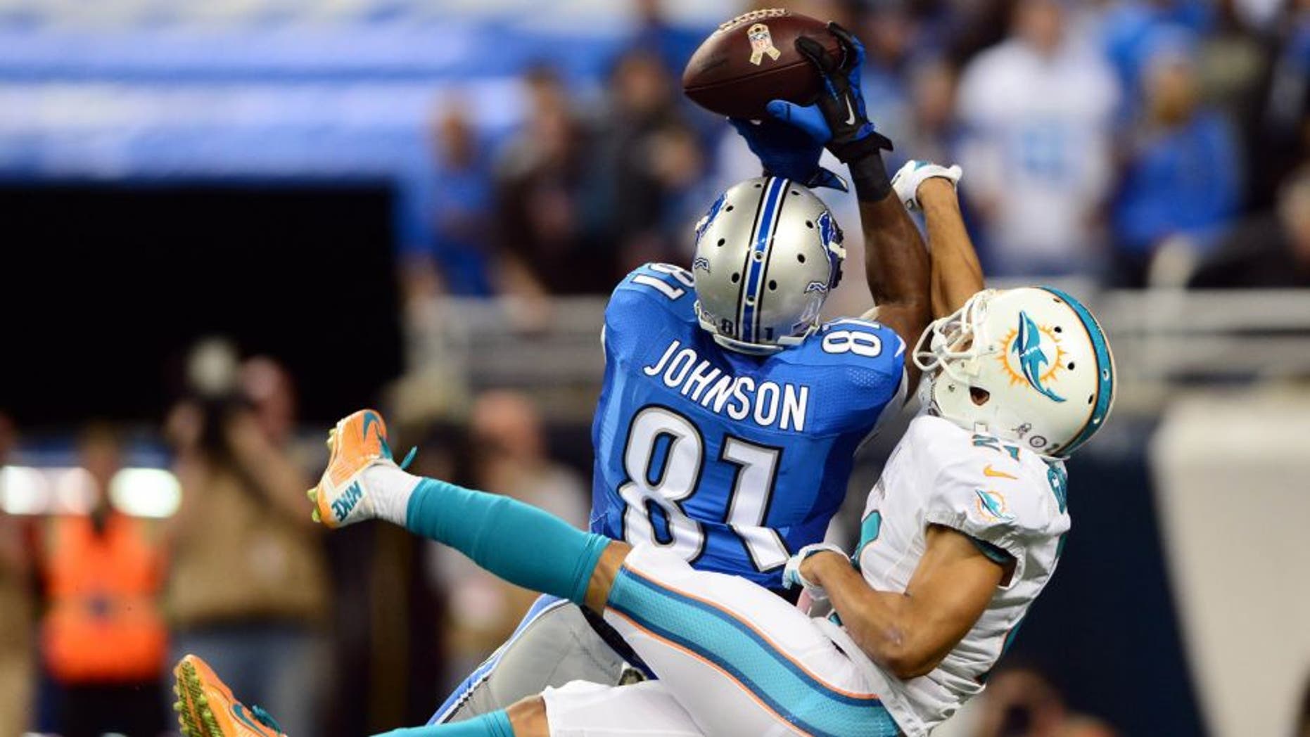 Nov 9, 2014; Detroit, MI, USA; Detroit Lions wide receiver Calvin Johnson (81) catches a pass while being defended by Miami Dolphins cornerback Brent Grimes (21) for a touchdown during the first quarter at Ford Field. Mandatory Credit: Andrew Weber-USA TODAY Sports