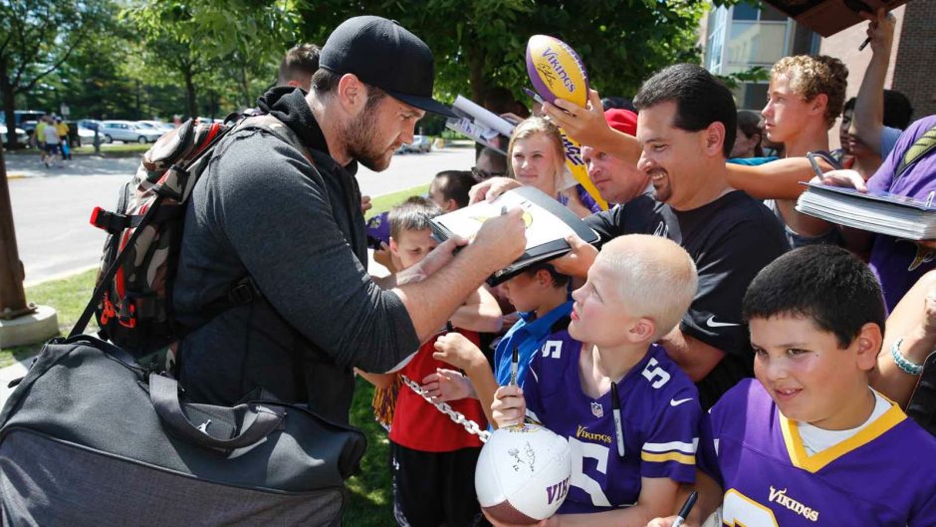 Minnesota Vikings linebacker Casey Matthews signs autographs as he reports to training camp on the campus of Minnesota State University, Saturday, July 25, 2015, in Mankato.