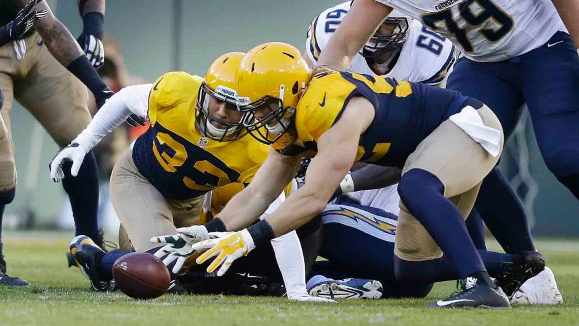 The Green Bay Packers' Clay Matthews recovers a fumble by the San Diego Chargers' Melvin Gordon during the first half Sunday, Oct. 18, 2015, in Green Bay, Wis.