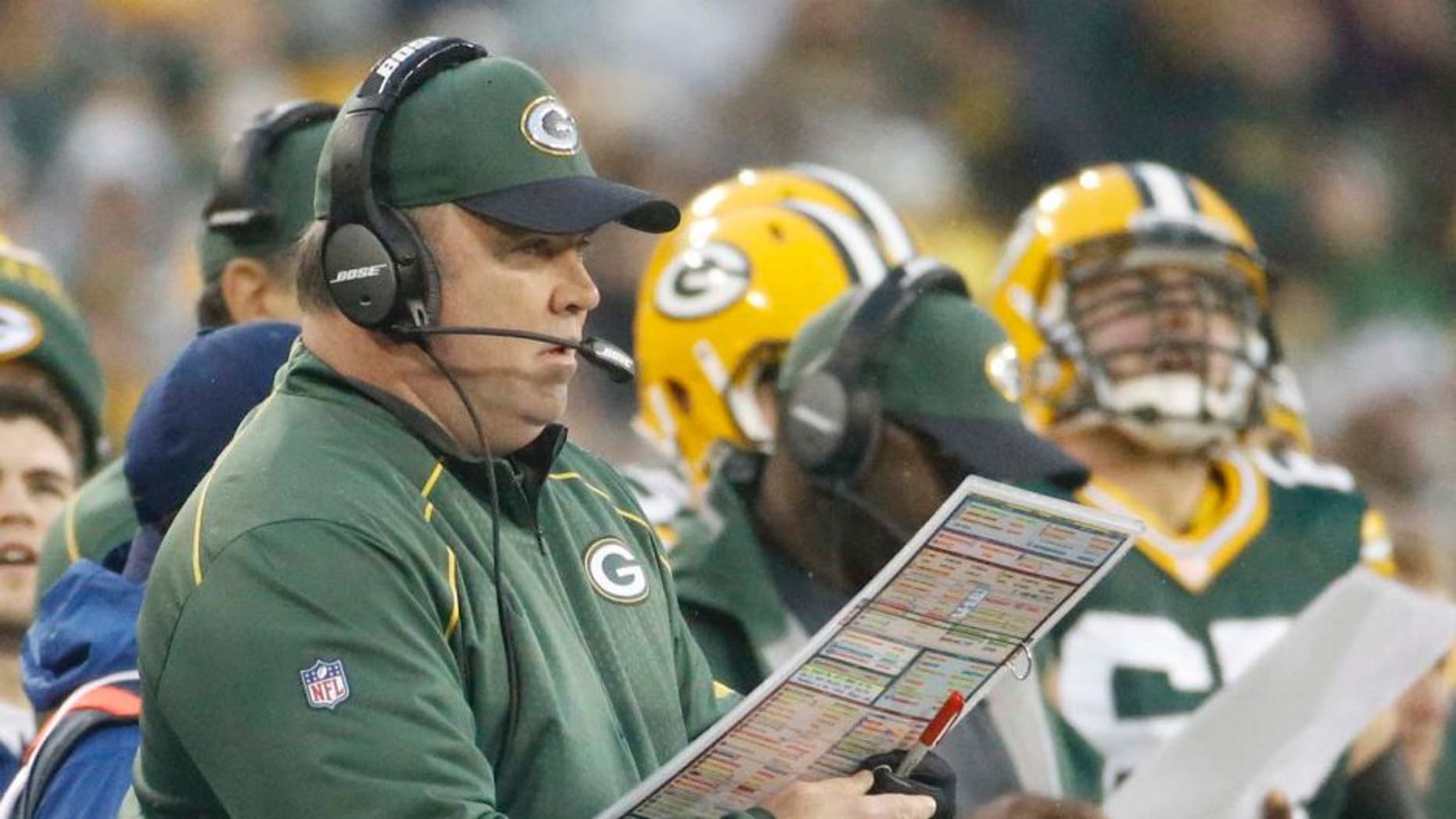 Green Bay Packers head coach Mike McCarthy calls a play during the first half against the Dallas Cowboys in Green Bay, Wis., on Sunday, Dec. 13, 2015.