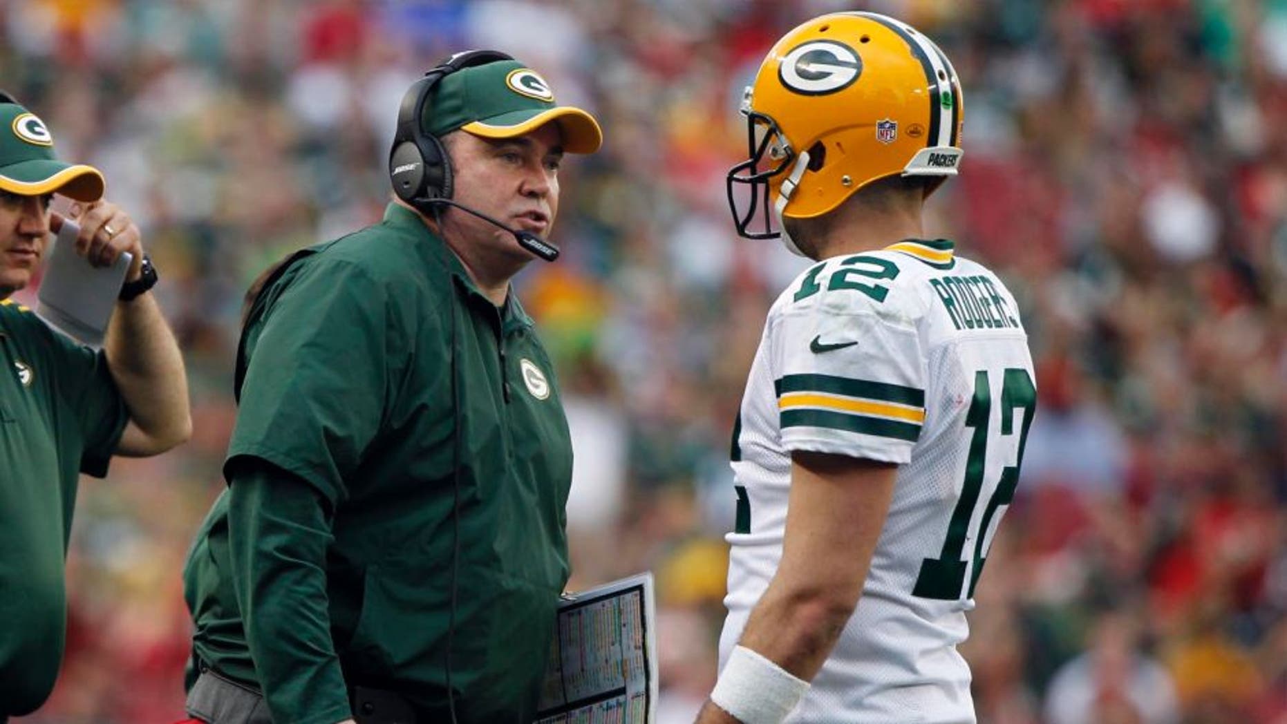 Dec 21, 2014; Tampa, FL, USA; Green Bay Packers head coach Mike McCarthy talks with quarterback Aaron Rodgers (12) against the Tampa Bay Buccaneers during the second half at Raymond James Stadium. Green Bay Packers defeated the Tampa Bay Buccaneers 20-3. Mandatory Credit: Kim Klement-USA TODAY Sports
