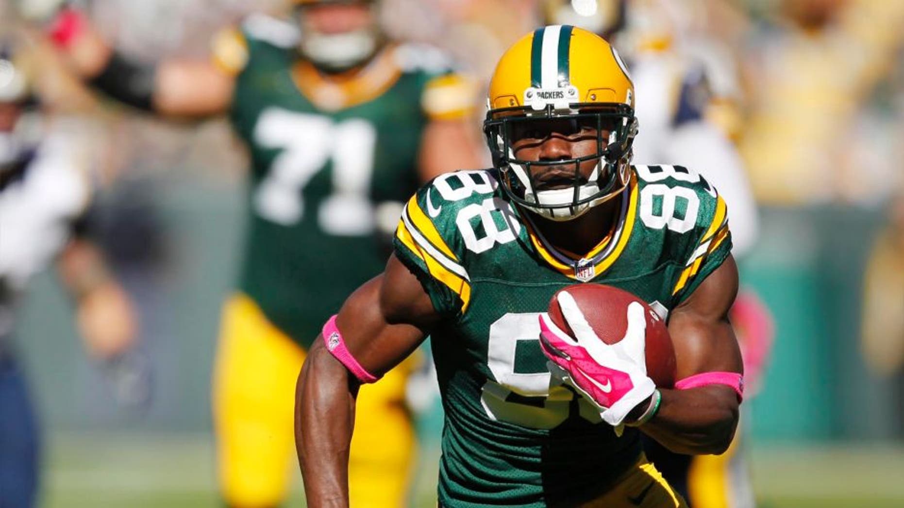 The Green Bay Packers' Ty Montgomery catches a touchdown pass during the first half against the St. Louis Rams on Sunday, Oct. 11, 2015, in Green Bay, Wis.